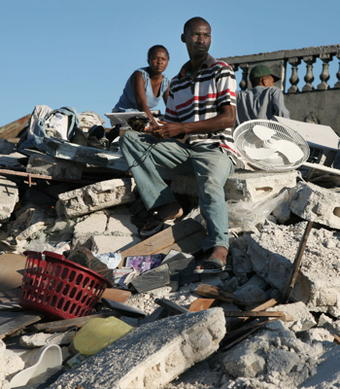 HAITI_QUAKE_12_small.jpg Man sits on top of earthquake rubble in Haiti (NYT Photo)