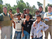 prt_iraq.jpg USIP officials on a recent trip to Iraq standing with children in a park reconstructed with US funds in Nasiriya