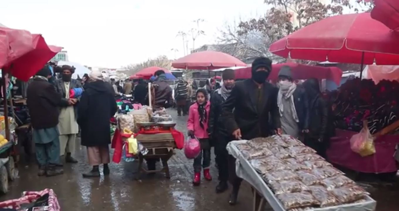 A market in the Kundz provincial capital is filled mainly with men