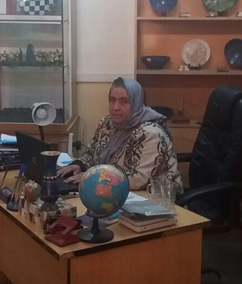 Ayesha Aziz works at her office, which is adorned by samples of Afghan gemstones and crafts.