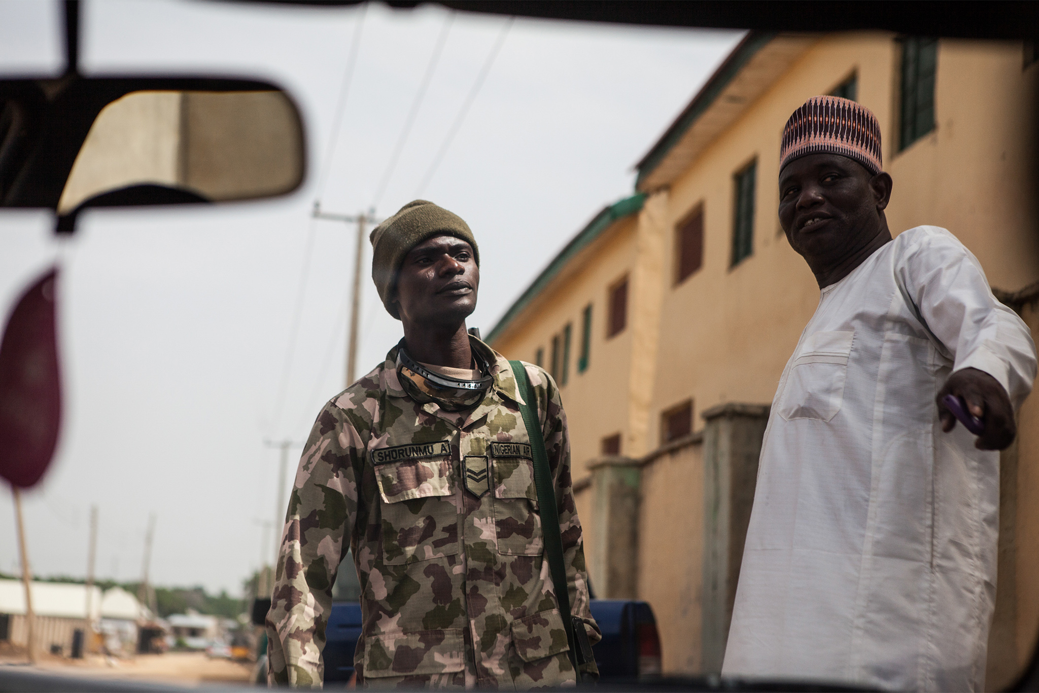 A member of the Nigerian military speaks with a man on the street in Maiduguri, Nigeria, June 16, 2016. 