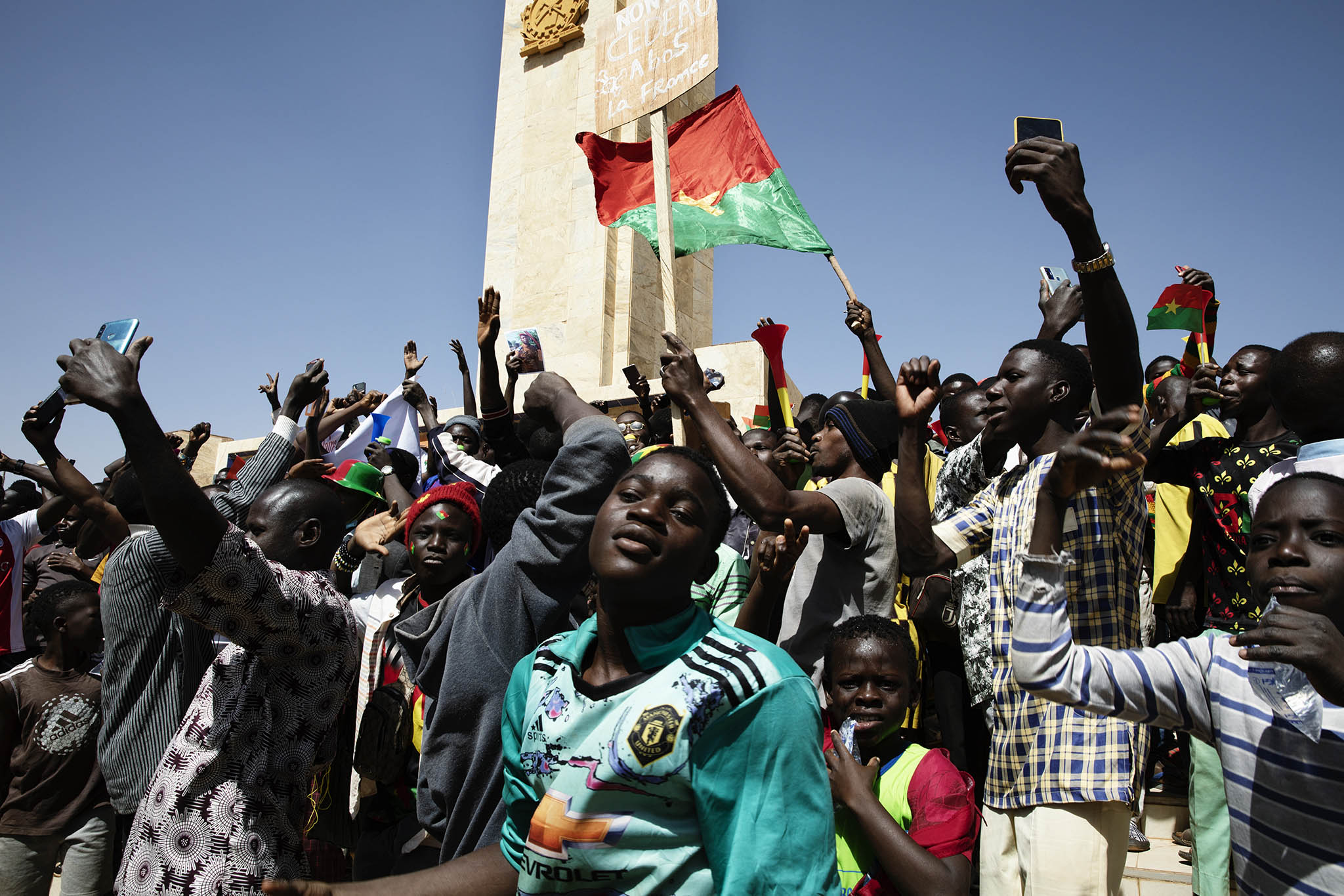 Young Burkinabe gather in the capital, Ouagadougou, following Burkina Faso’s January 2022 coup d’état. Burkina Faso’s junta, like those of Mali and Niger, has resisted pressures for an early return to civilian rule. (Malin Fezehai/The New York Times)