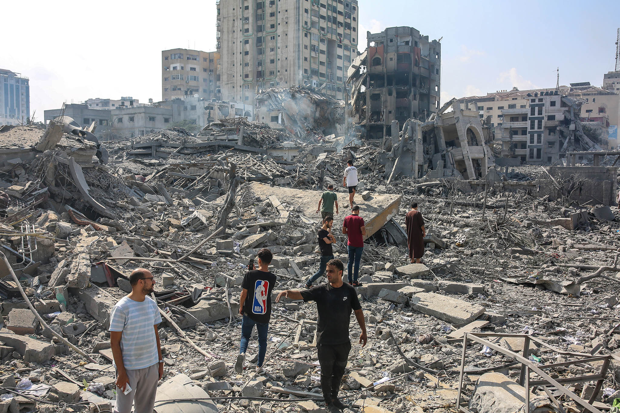 Palestinian citizens inspect the destruction caused to the Al-Rimal neighborhood due to raids by Israeli warplanes in the central Gaza Strip on Oct. 10, 2023. (Samar Abu Elouf/The New York Times)