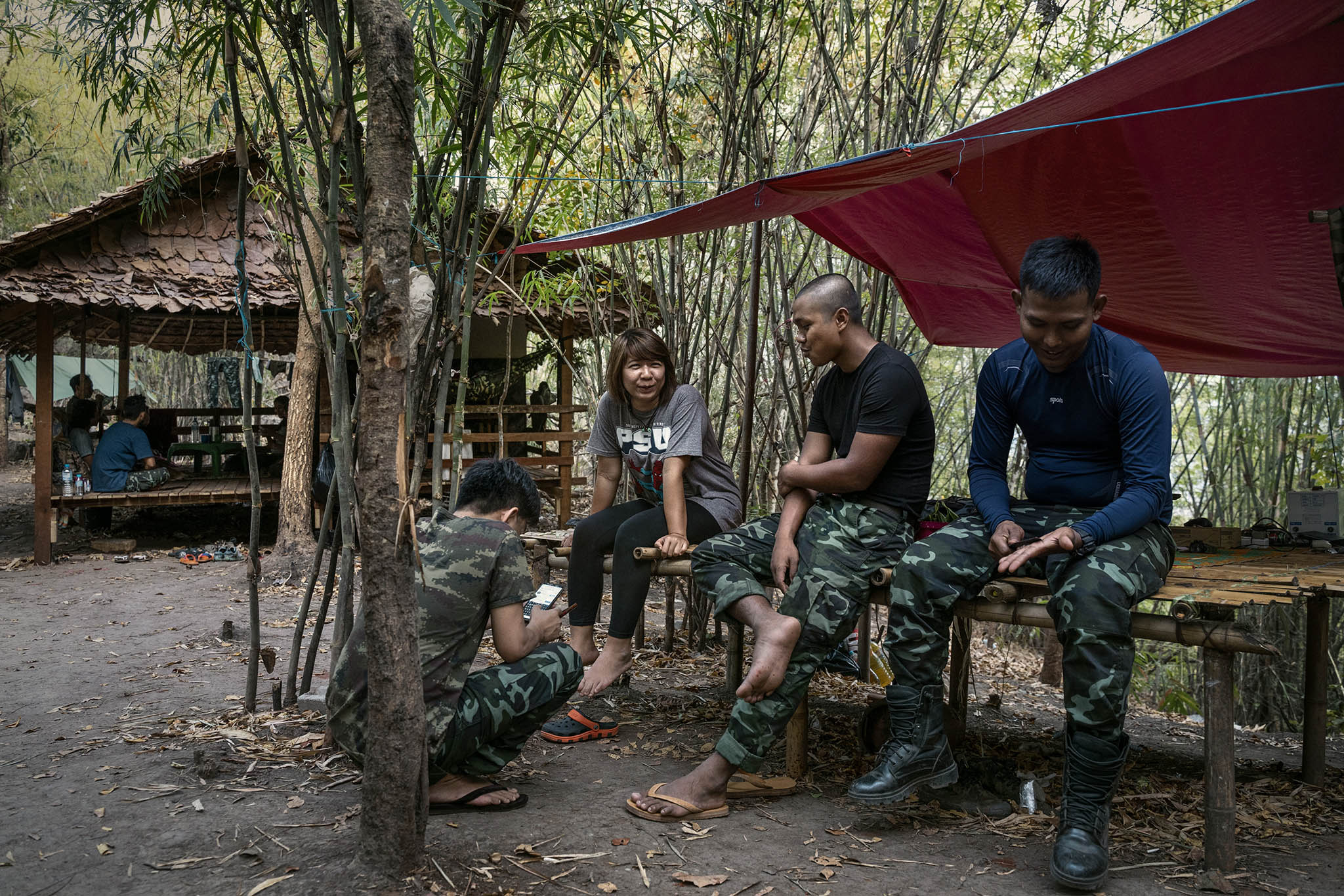 Fighters and supporters of an ethnic armed group discuss their battle against Myanmar’s junta at a camp in the country’s east in 2022. A more unified offensive by such groups has pushed back junta forces since late 2023. (Adam Dean/The New York Times)