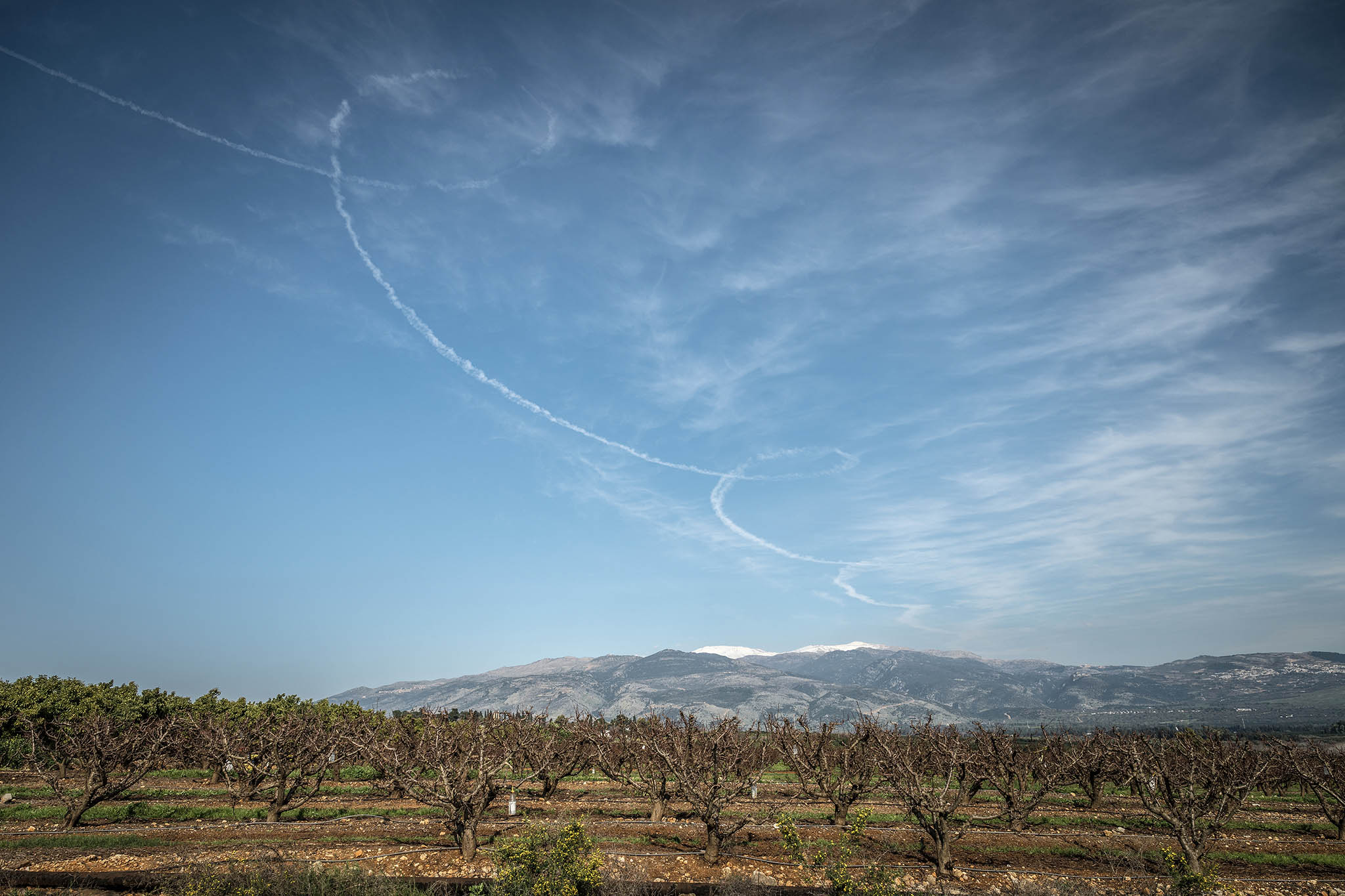 The looping contrails from a Hezbollah rocket, near Kiryat Shimona, Israel, a city on the border with Lebanon, Feb. 26, 2024. (Sergey Ponomarev/The New York Times)
