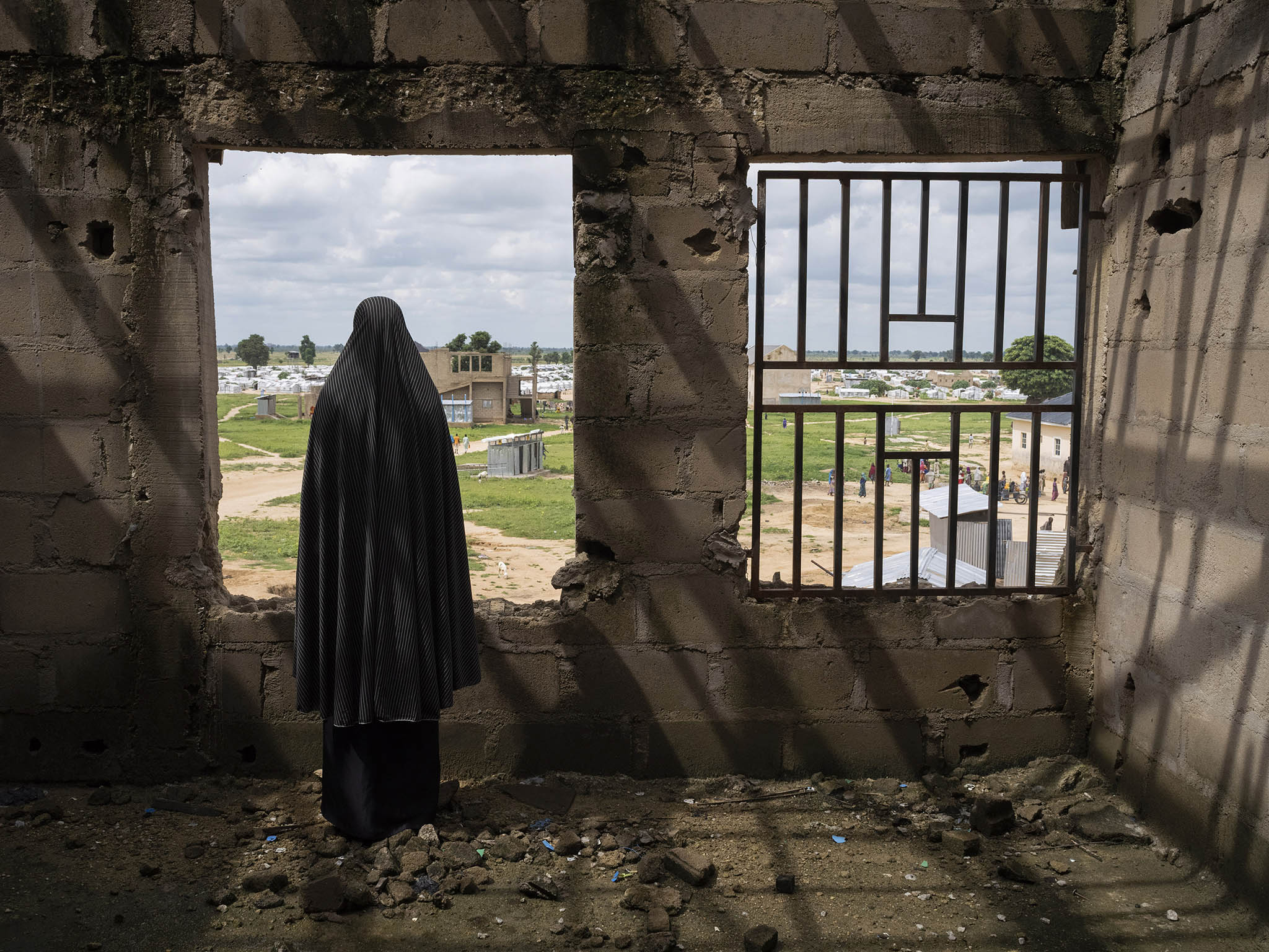 A woman who was kidnapped by Boko Haram and recruited as a bomber at an abandoned building at a camp for displaced people in Konduga, Nigeria. August 20, 2019. (Laura Boushnak/The New York Times)