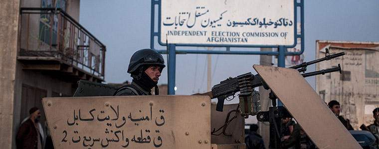 Afghan security forces block a street leading to the election commission. Insurgents attacked the Independent Election Commission offices, another in a series of strikes on foreign targets & the commission running the vote. Photo: NYT/ Bryan Denton