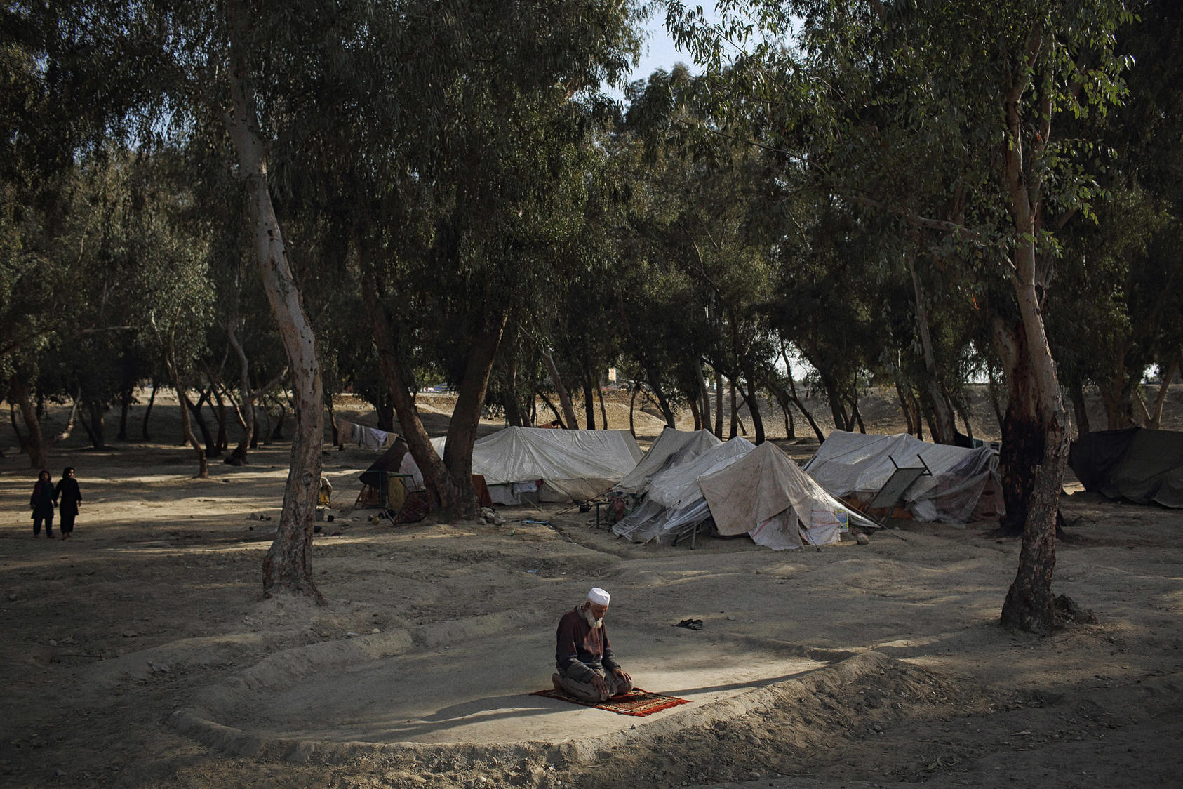 Haji Hazrat prays on the fringe of a makeshift camp in Jalalabad, Afghanistan. Afghan refugees say they are being forced to return to their homeland after a terrorist attack on a school in Pakistan fueled a new wave of resentment against them. The New York Times/Andrew Quilty