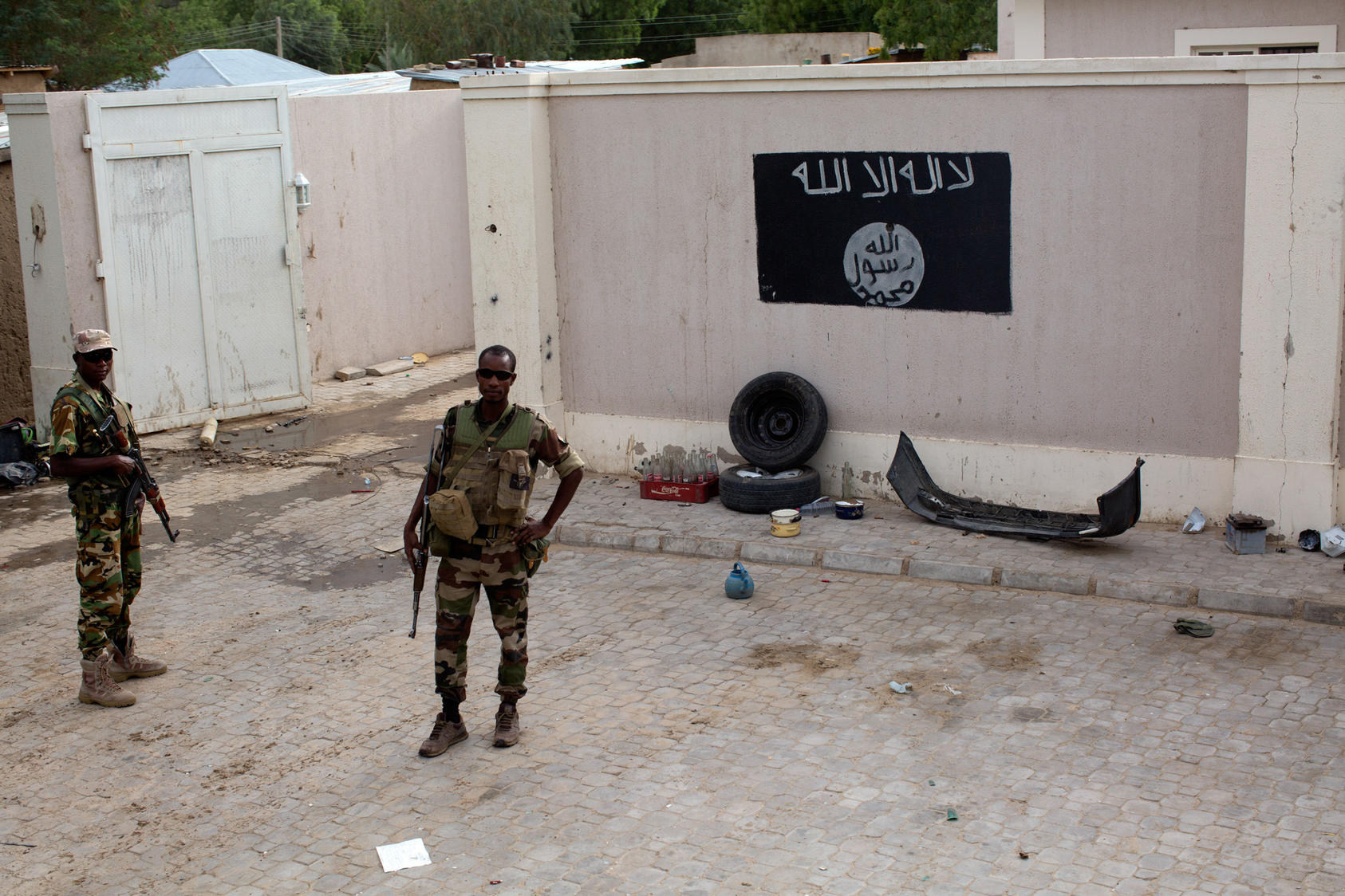 Chadian soldiers stand near a Boko Haram flag, one of many in the now-liberated — and deserted — city of Damasak, in northern Nigeria, March 18, 2015. Though the Nigerian government insists its forces have chased Boko Haram out if much of its territory, only soldiers from Chad and Niger were involved in liberating this once-thriving city of 200,000. 
