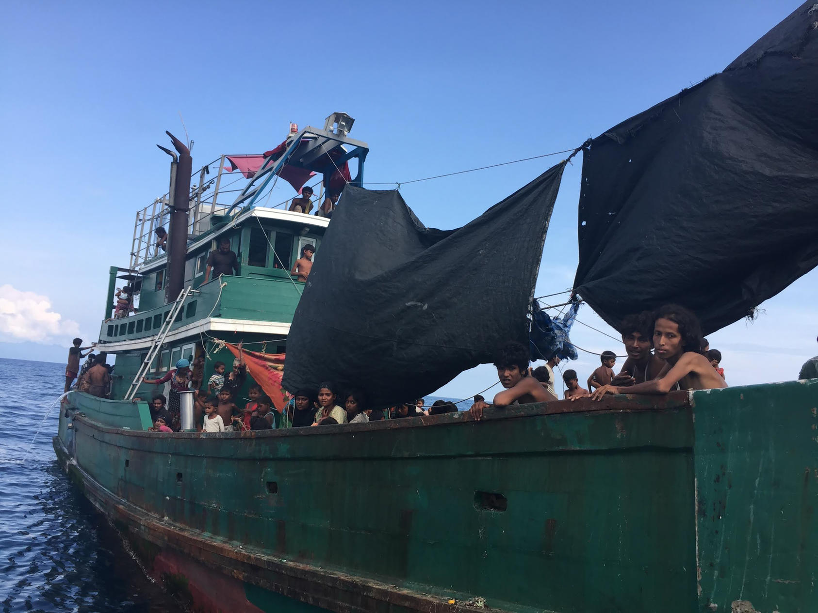 A wooden fishing boat carrying several hundred Rohingya migrants from Myanmar adrift west of the Thai mainland, May 14, 2015. The boat, which migrants said that they had been on for three months, was part of an exodus in which thousands of people have taken to the sea in recent weeks but no country has been willing to take them in. (Thomas Fuller/The New York Times)