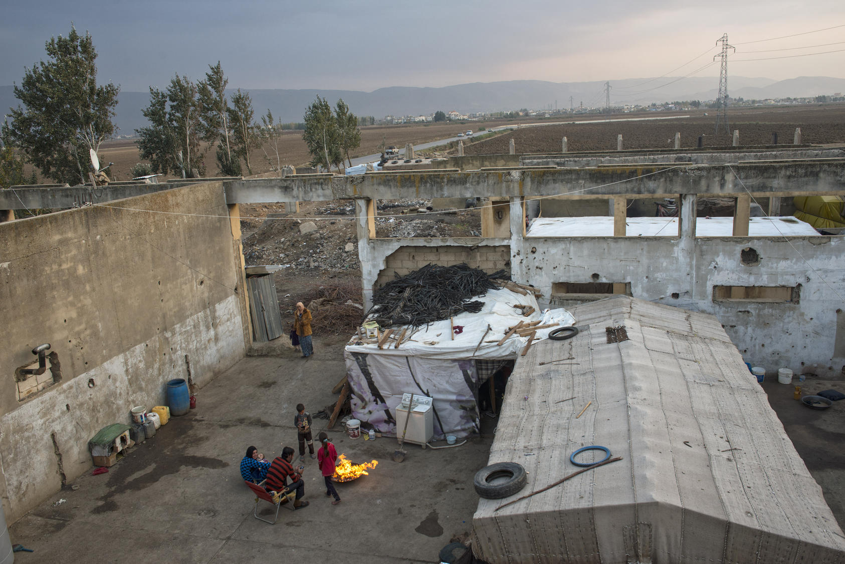 Syrian refugees live in a factory bombed by the Israeli military in 1982 near Faida, Lebanon. Photo Courtesy of The New York Times/ Lynsey Addario