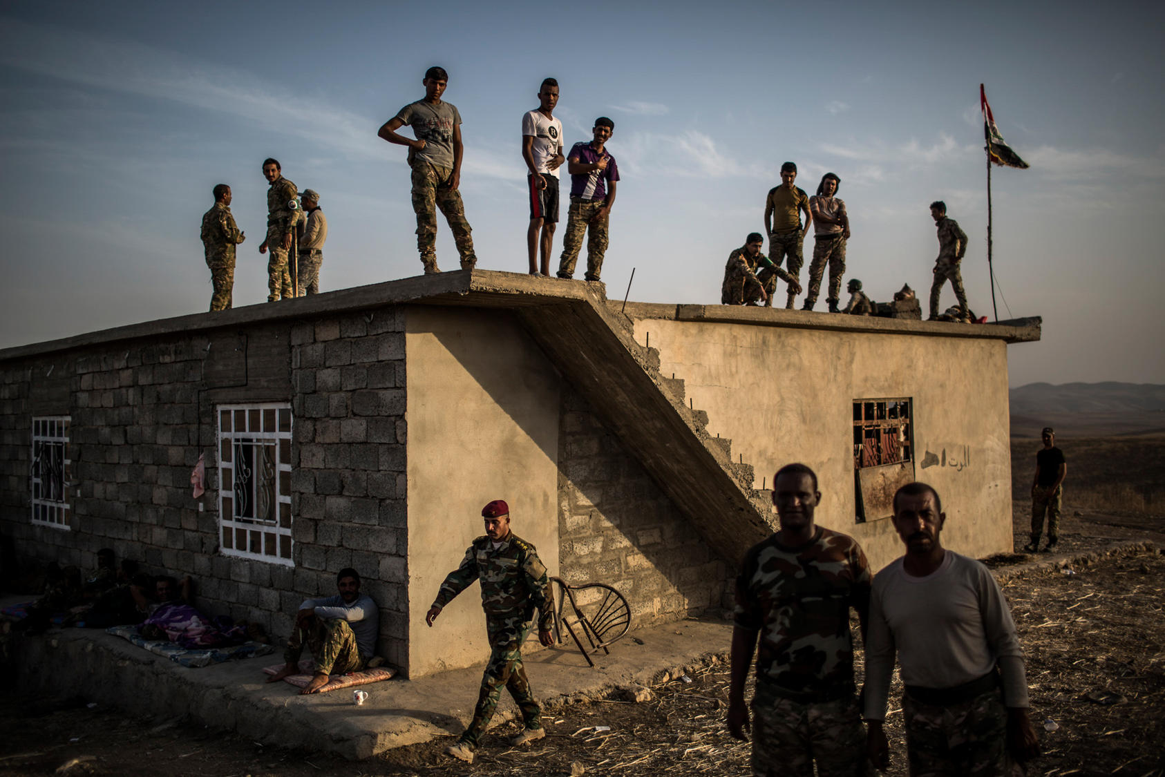 Sunni Arab fighters, many of whom fled Mosul when the Islamic State group captured the city two years ago, wait at their base near the Mosul Dam Oct. 18, 2016. Photo Courtesy of The New York Times/Bryan Denton
