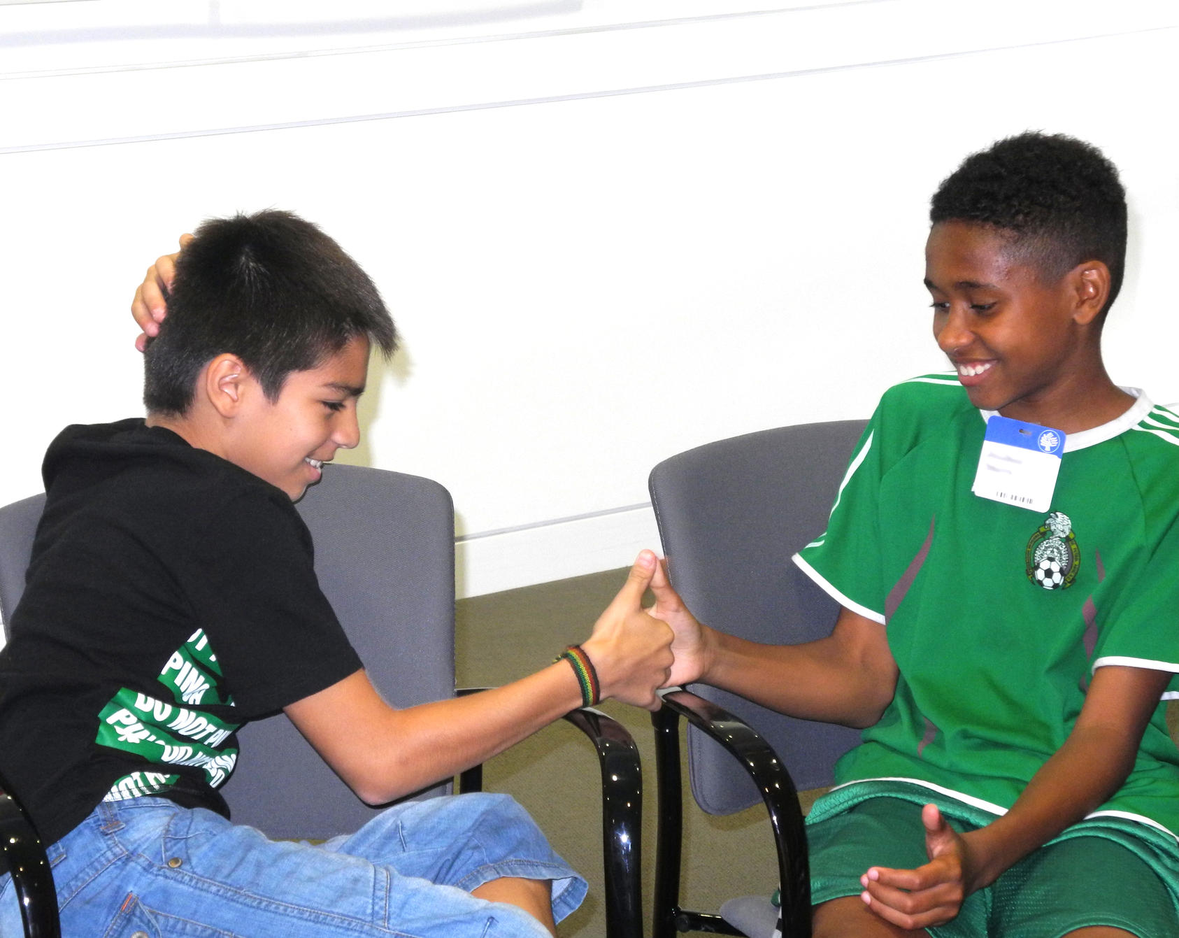 Students participating in the Thumb Wrestling: Competition Versus Cooperation activity at USIP.  