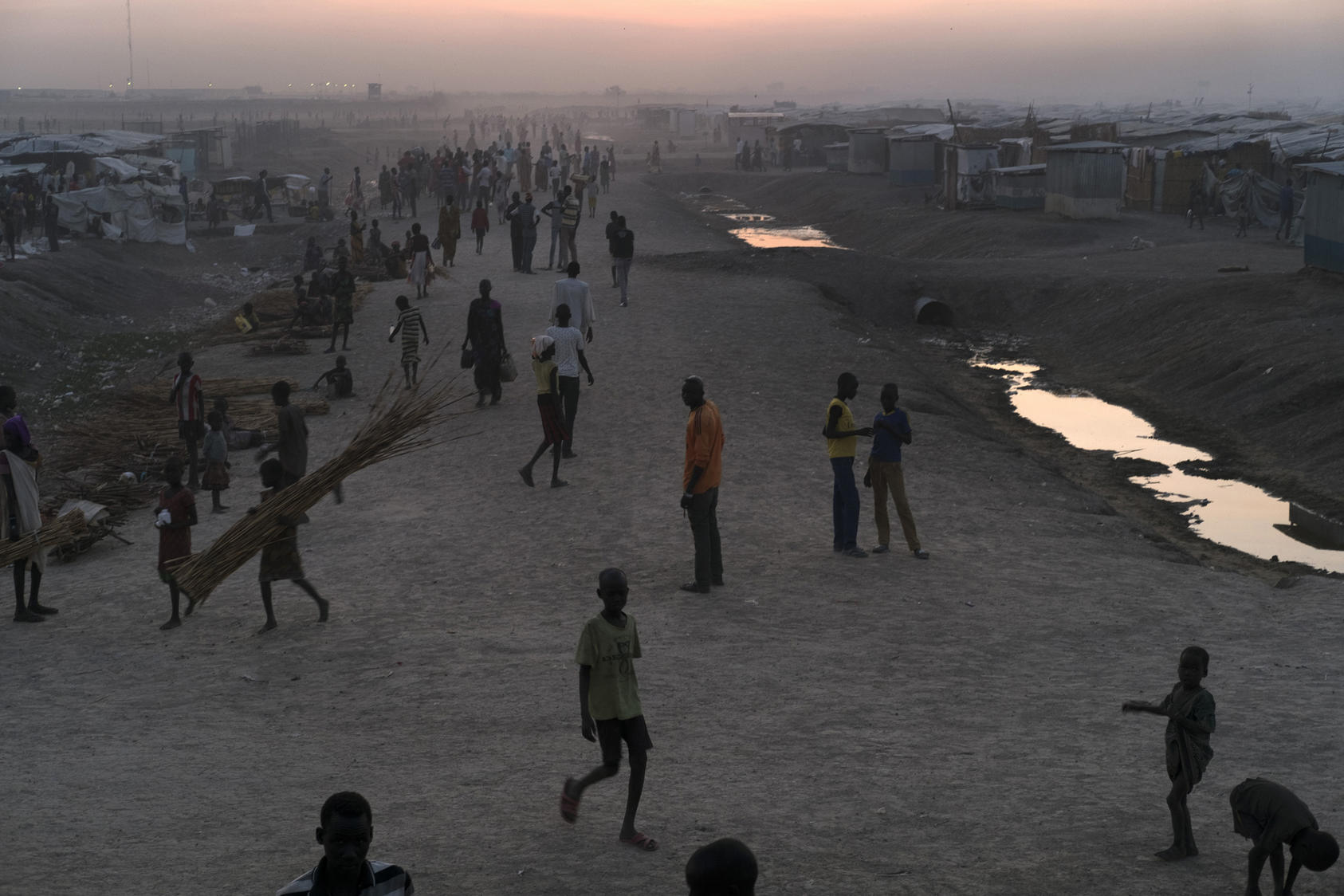 Displaced residents at a camp of makeshift tents and structures of sheet metal and plastic in Bentiu, South Sudan.