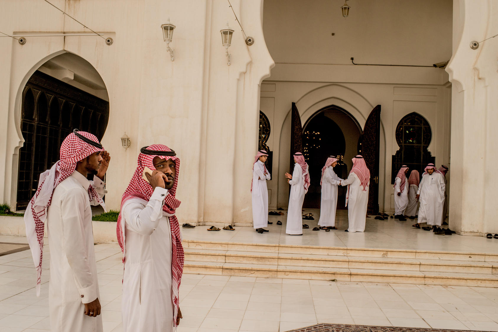 Men arrive for prayers at a mosque in Riyadh, Saudi Arabia