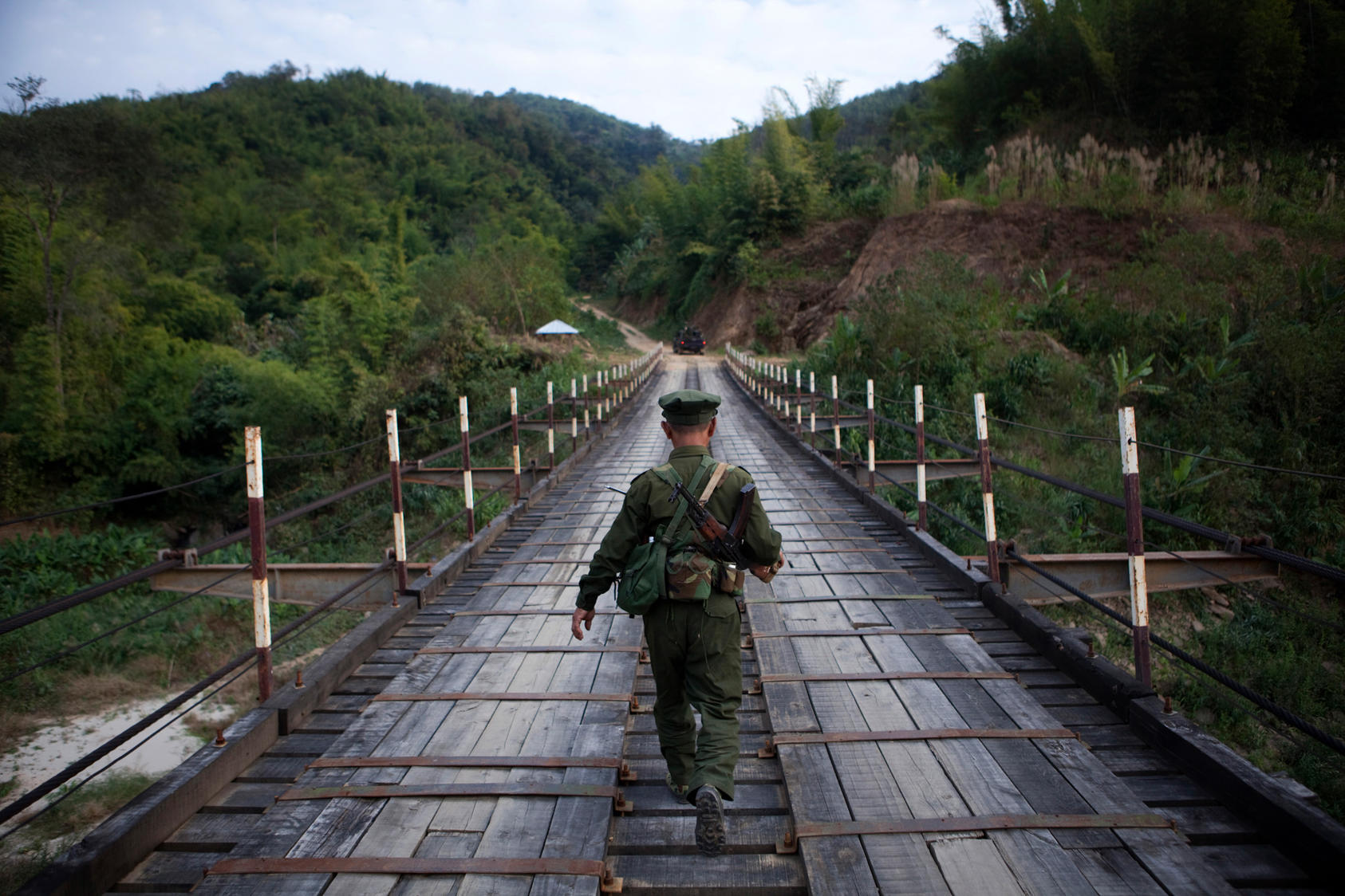 A Kachin Independence Army soldier travels across a bridge to the front lines between Laiza and Maija Yang in Myanmar, Jan. 9, 2012.