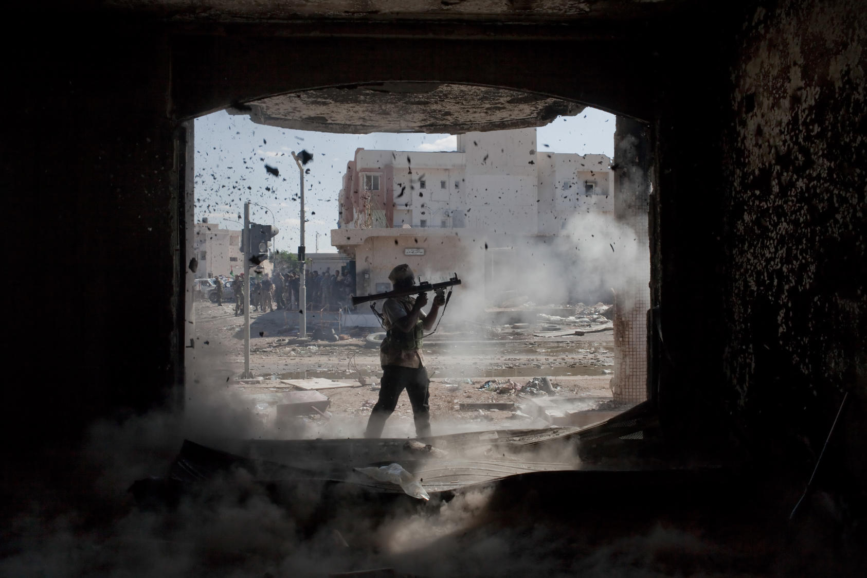 An anti-Gadhafi fighter fires a rocket-propelled grenade during fighting in Sirte, Libya.