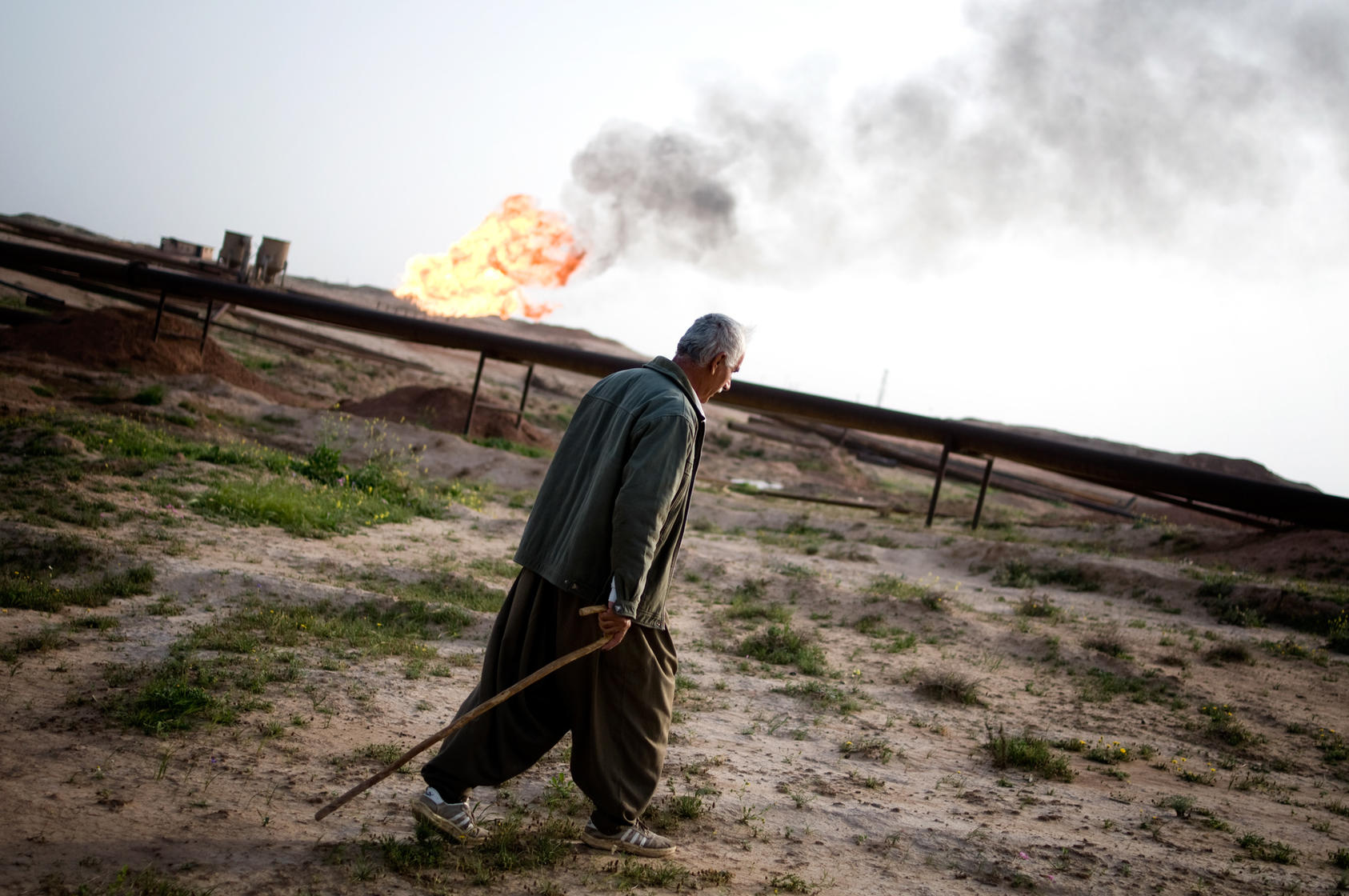 A Kurdish shepherd passes a flare from an oil well in Kirkuk, Iraq, March 12, 2010. Iraqi Kurds are selling oil and natural gas directly to Turkey, infuriating Washington and the central government in Baghdad, which fear that oil independence could lead Kurds to declare a broad independence and the fracturing of the nation. (Ayman Oghanna/The New York Times)
