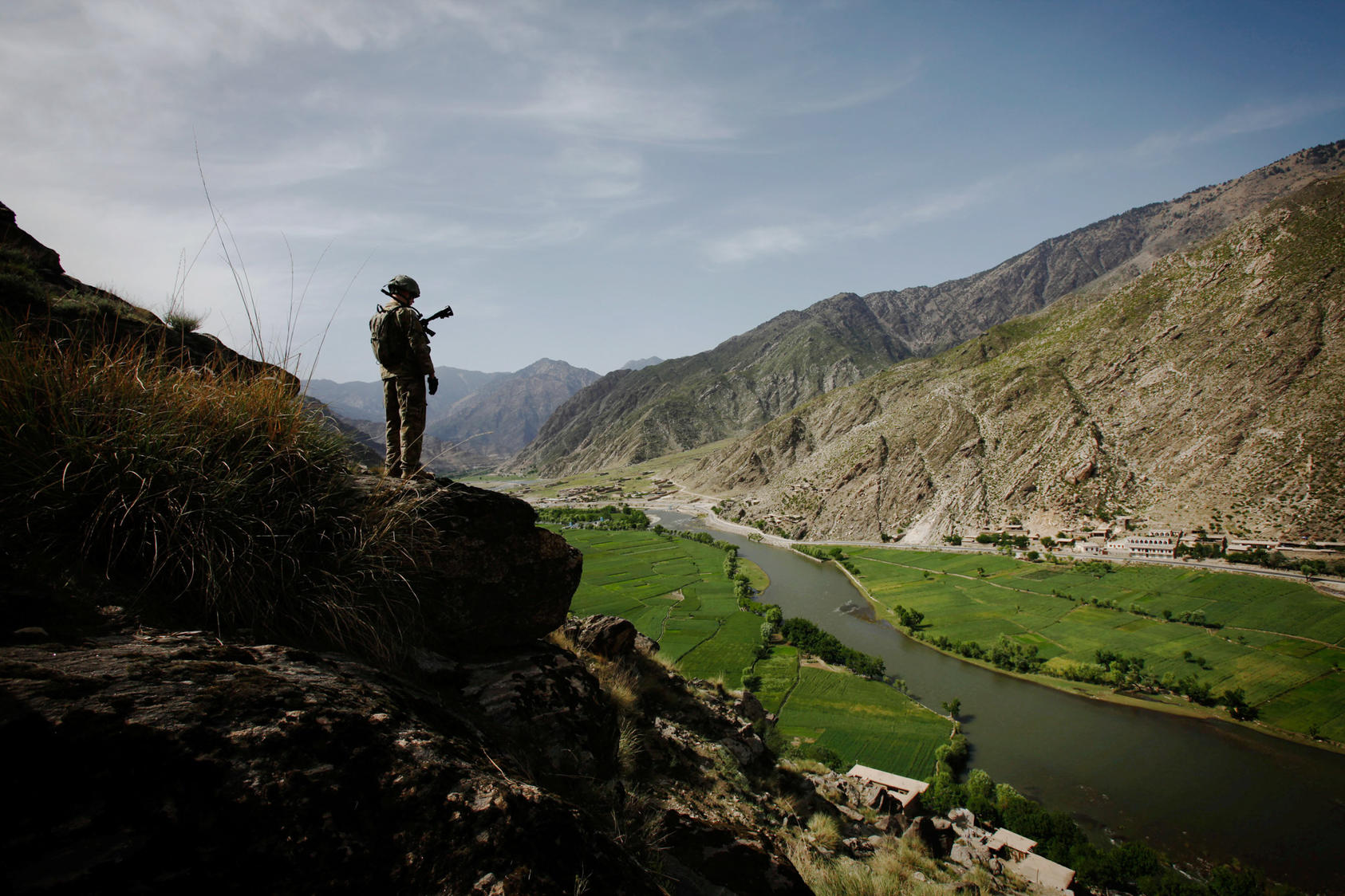 A soldier with U.S. Army's 4th Brigade looks over the Pech Valley in the Kunar province of Afghanistan, April 13, 2010. Photo Courtesy of The New York Times/Christoph Bangert