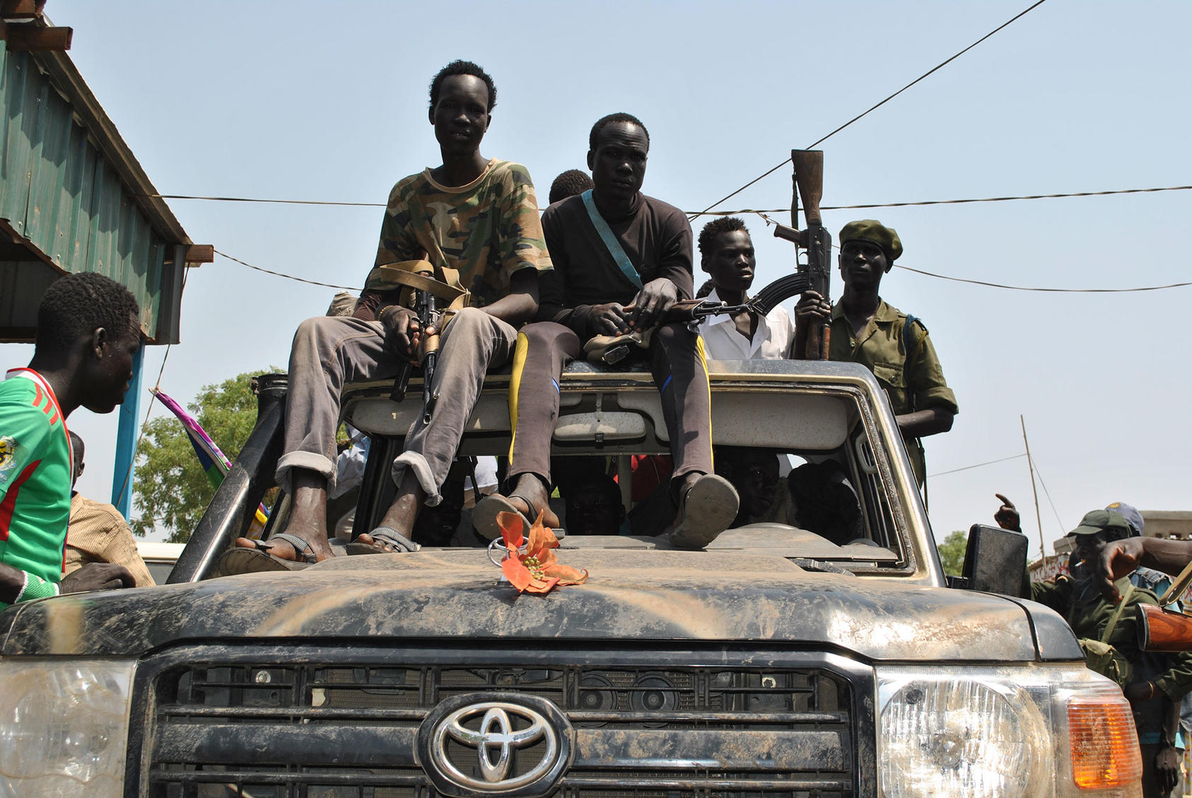 Civilian militantssit atop a truck in Nasir, South Sudan