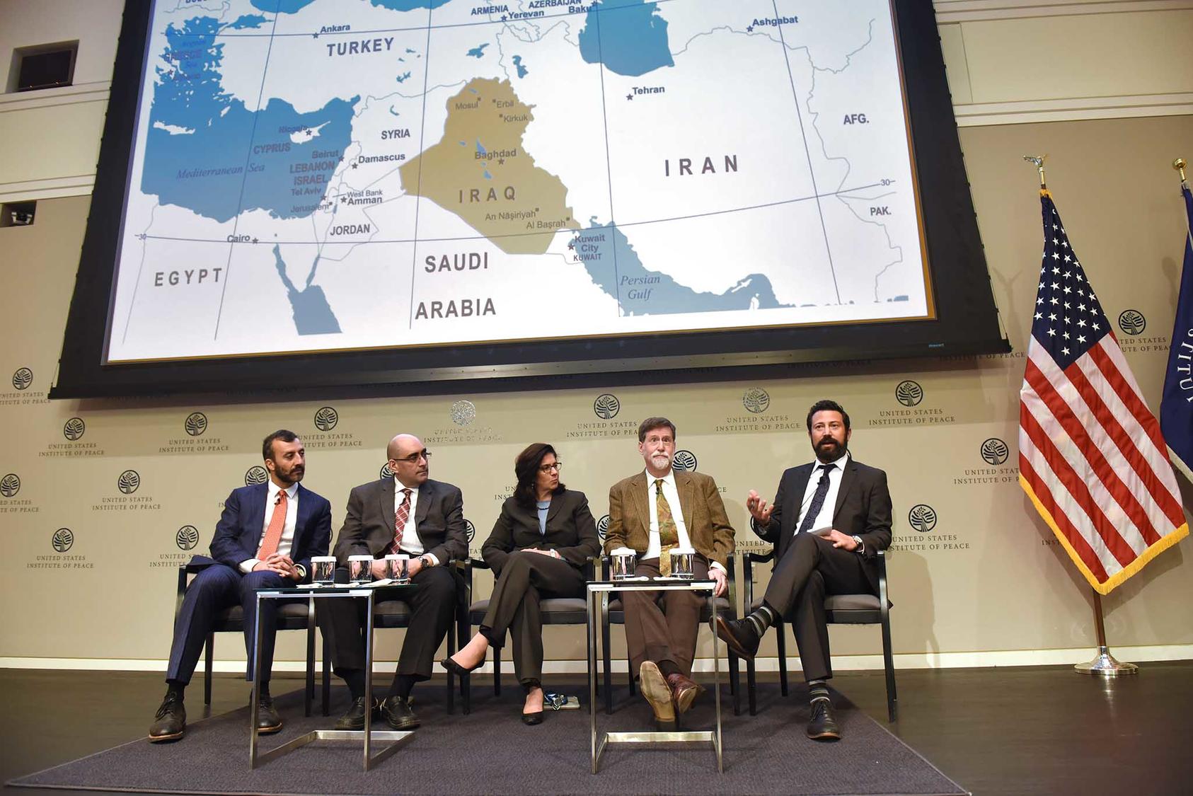 Panelists from the second discussion of the day discussed the region surrounding Iraq and Syria with a map displayed overhead