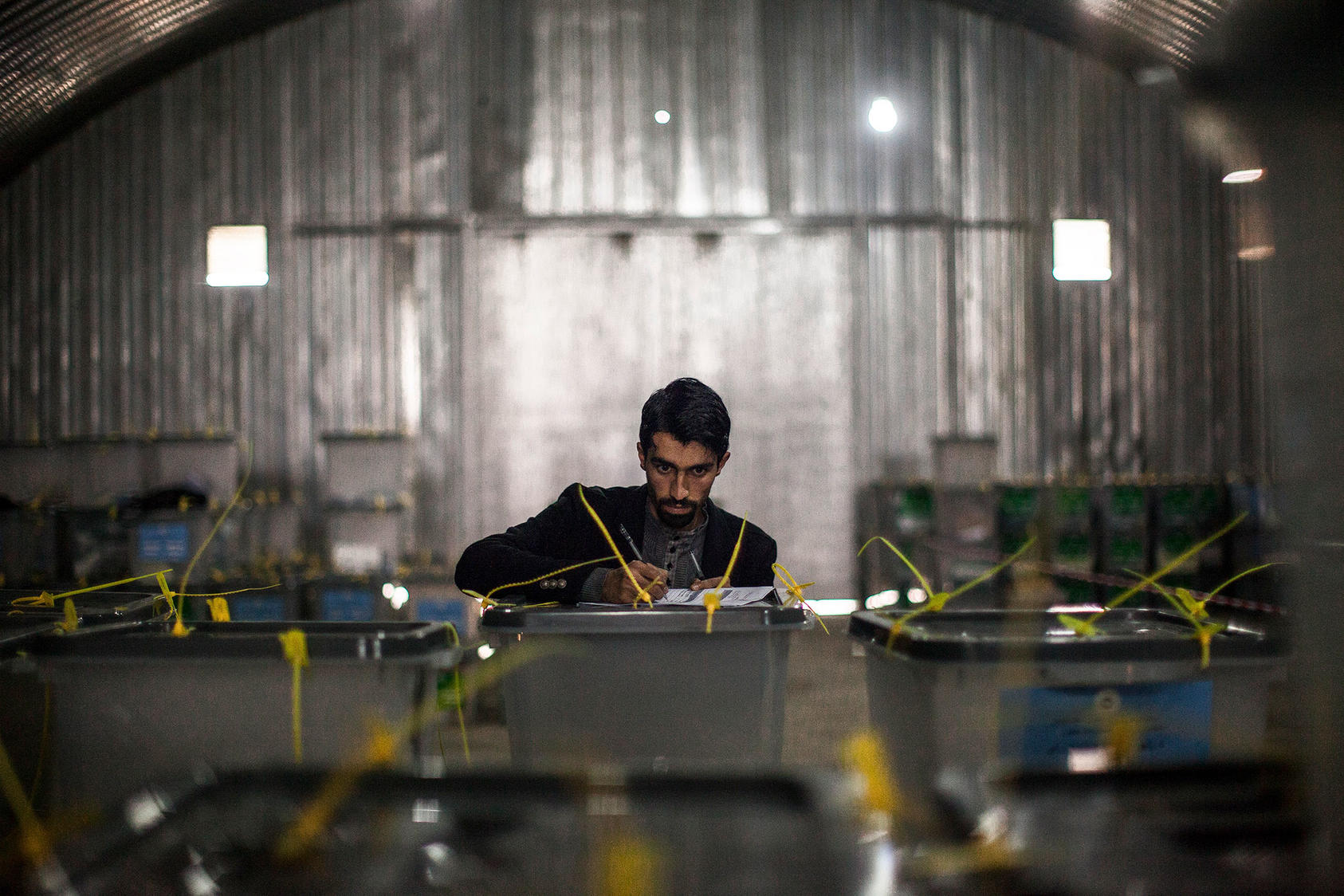 A man working for the Afghan Independent Election Commission inventories ballot boxes at IEC headquarters in Kabul