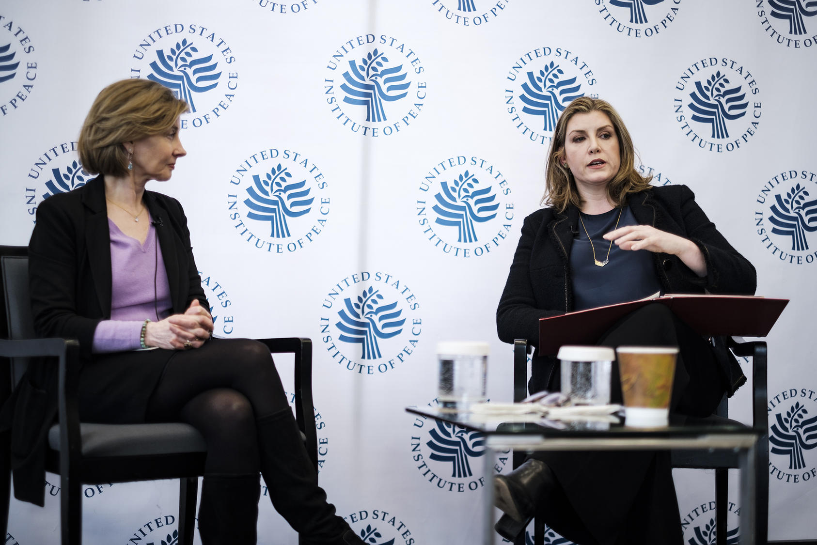 Penny Mordaunt (right), U.K. secretary of state for international development and minister for women and equalities, talks with Nancy Lindborg (left), president of the U.S. Institute of Peace.