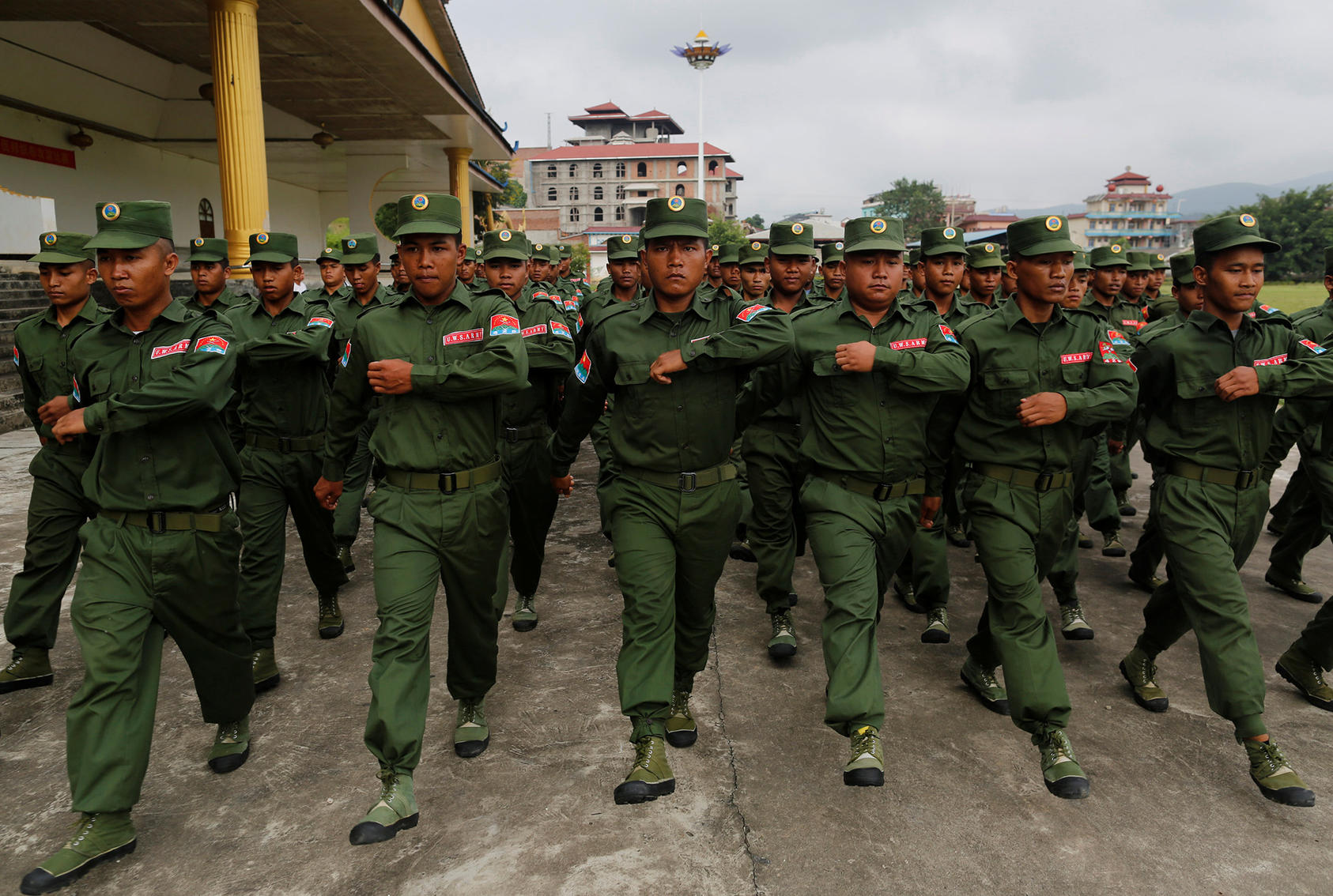 United Wa State Army soldiers march during a media display in Panghsang, in the Wa Self-Administered Division of Shan State, Burma. (Photo by Soe Zeya Tun/Reuters)