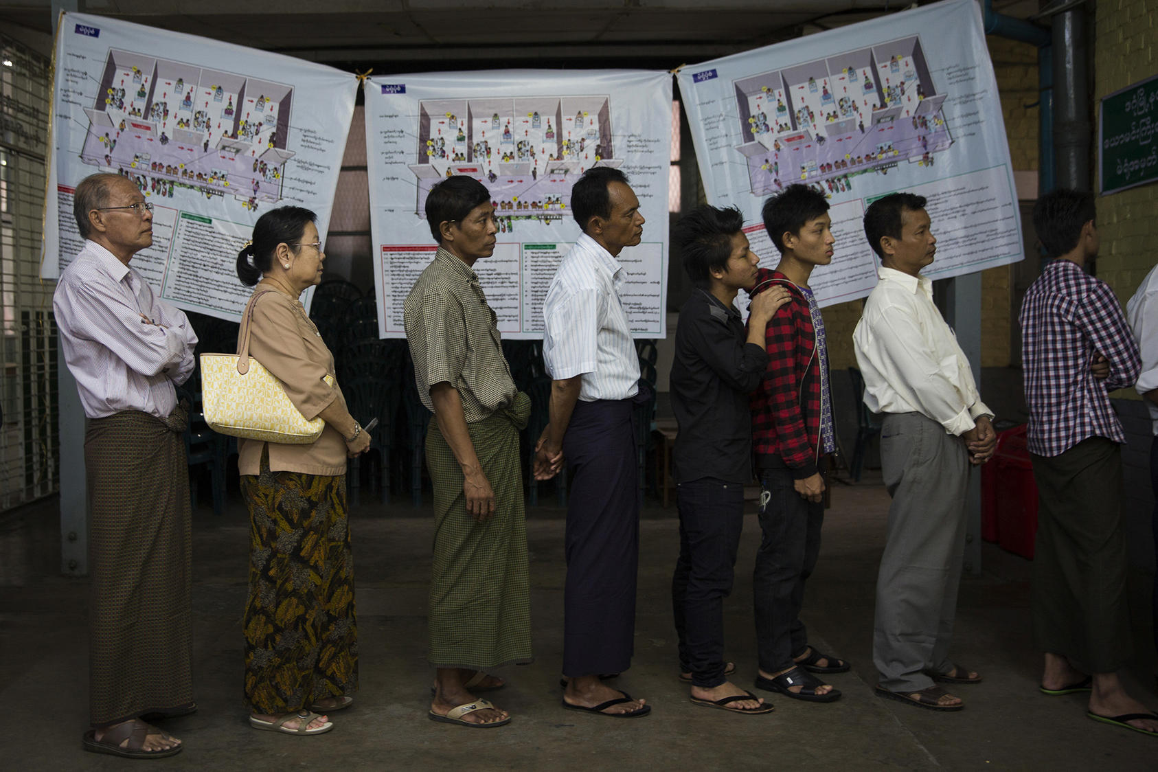 Voters line up at a polling station in Dagon High School in the Dagon township of Yangon, Myanmar, Nov. 8, 2015. (Adam Dean/The New York Times)