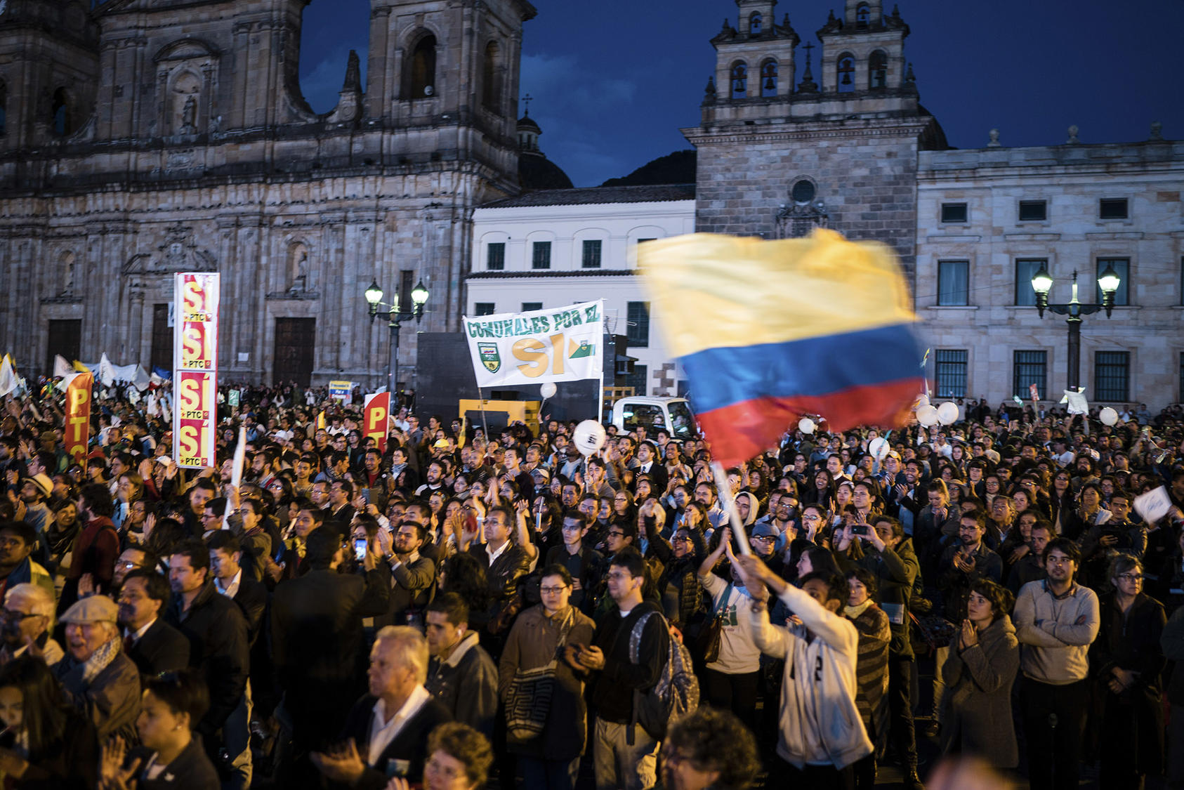 People celebrate the signing of a peace agreement between the Colombian government and the FARC, in Bogota, Sept. 26, 2016. (Federico Rios Escobar/The New York Times)