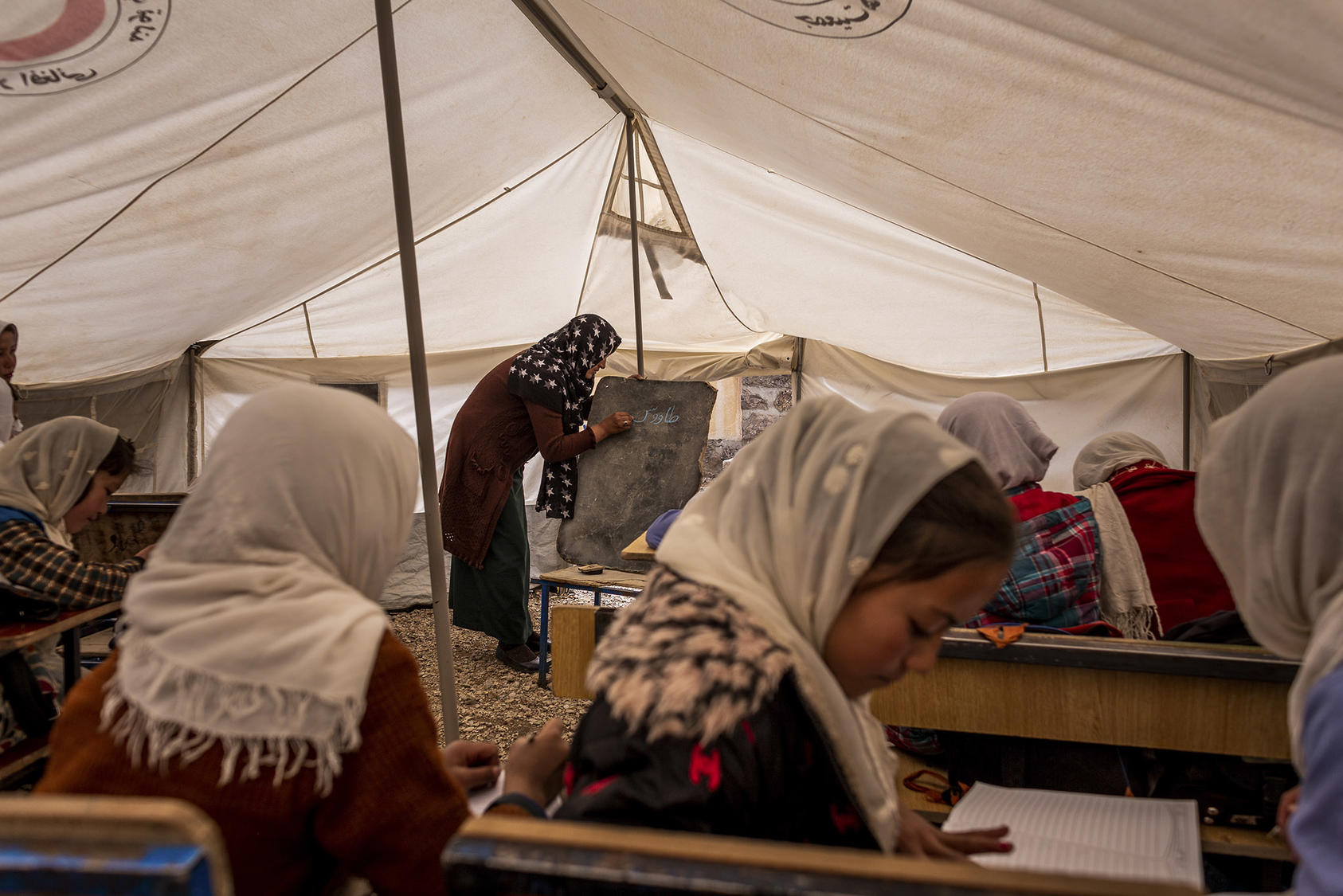 Girls study at a school housed in a tent in central Afghanistan. Afghan women leaders vow to work to preserve education for women and girls in any negotiations with the Taliban over the country’s future. (Jim Huylebroek/The New York Times)