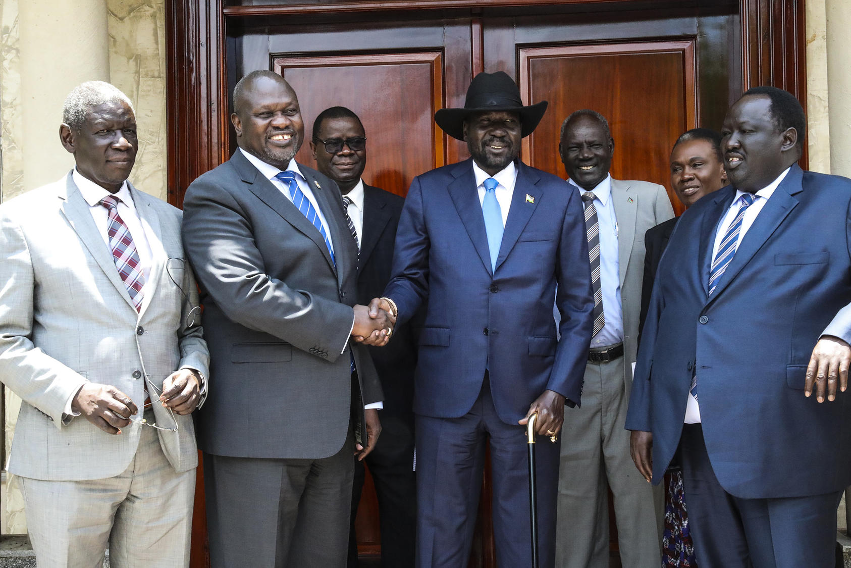Salva Kiir (center right), president of the Republic of South Sudan, shakes hands with Riek Machar, opposition leader, at the Presidential Palace in Juba, Sept. 11, 2019 (UN Photo/Isaac Billy)