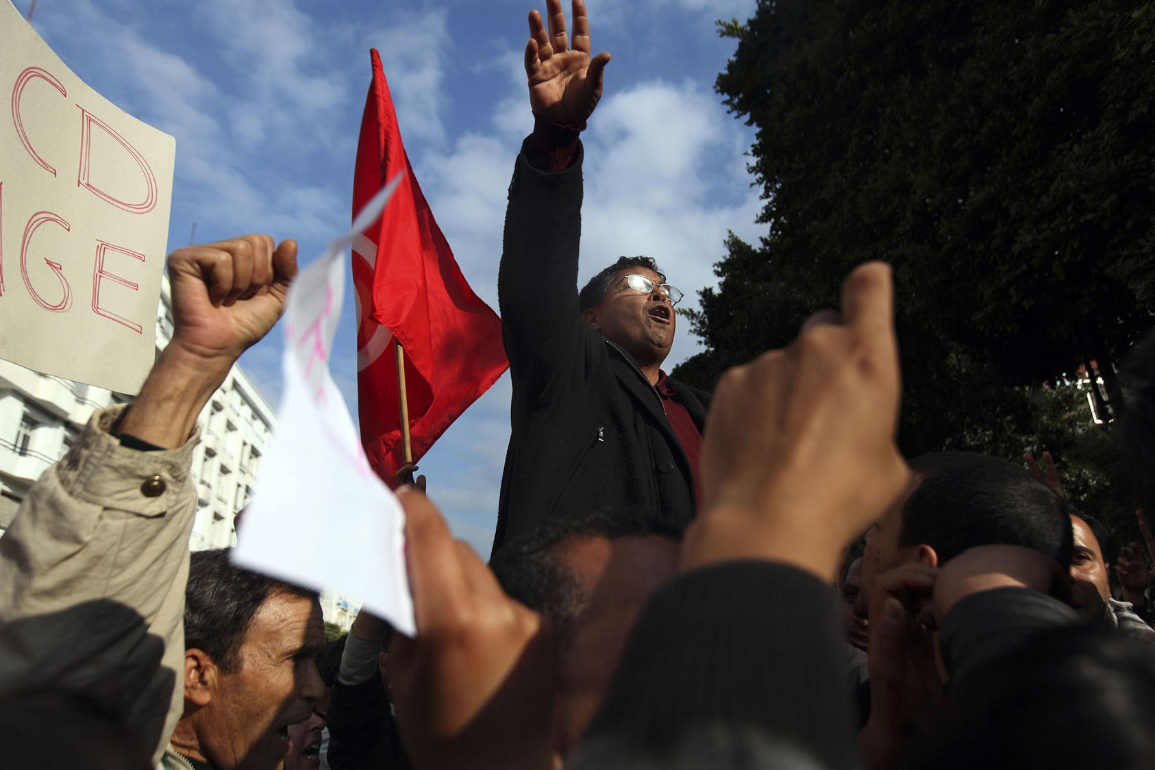Demonstrators sing the Tunisian National Anthem during a protest in Tunis, Tunisia, Jan. 19, 2011. (Holly Pickett/The New York Times)