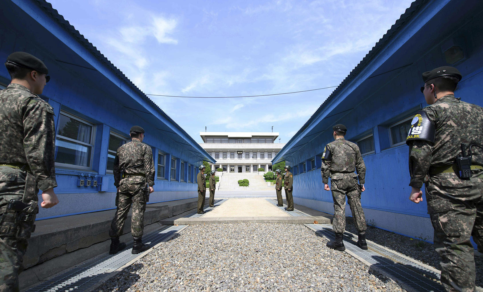 South Korean soldiers, front, and North Korean soldiers, rear, stand guard on either side of the Military Demarcation Line of the Demilitarized Zone dividing the two nations. (Korea Summit Press Pool via New York Times)