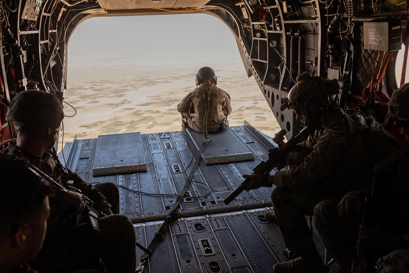 U.S. troops in a helicopter above Helmand Province in Afghanistan Sept. 26, 2019. (Jim Huylebroek/The New York Times)