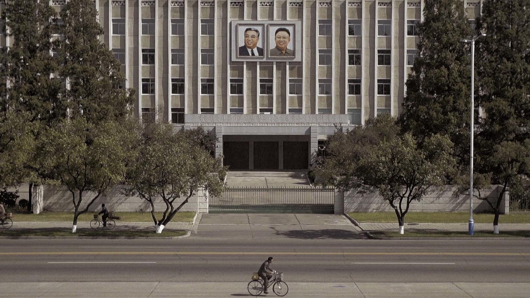 Portraits of Kim Il-Sung, the founder of North Korea and his son, Kim Jong-il, hang on a building in the capital, Pyongyang, Sept. 29, 2017. (Jonah M. Kessel/The New York Times)