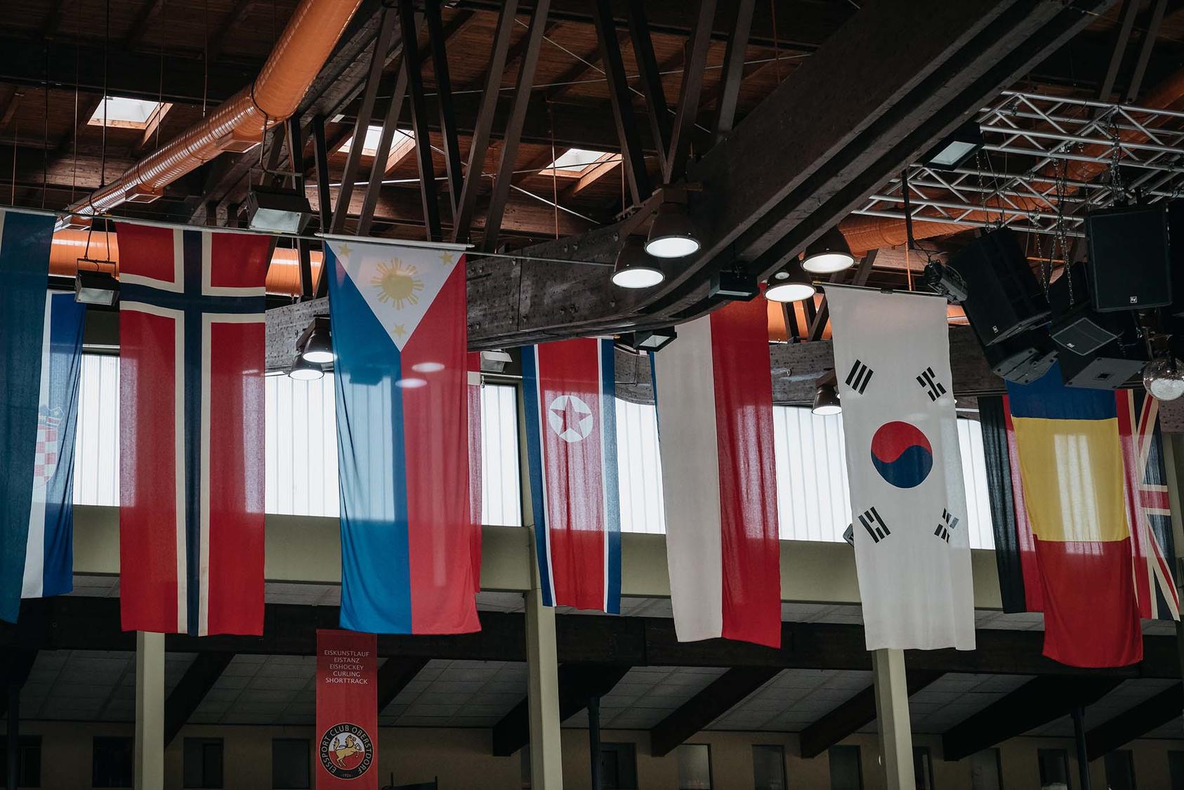 The North Korean flag, third left, hangs with those of other nations at the site of a figure skating competition in Oberstdorf, Germany, Sept. 27, 2017. Korea. (Jun Michael Park/The New York Times)