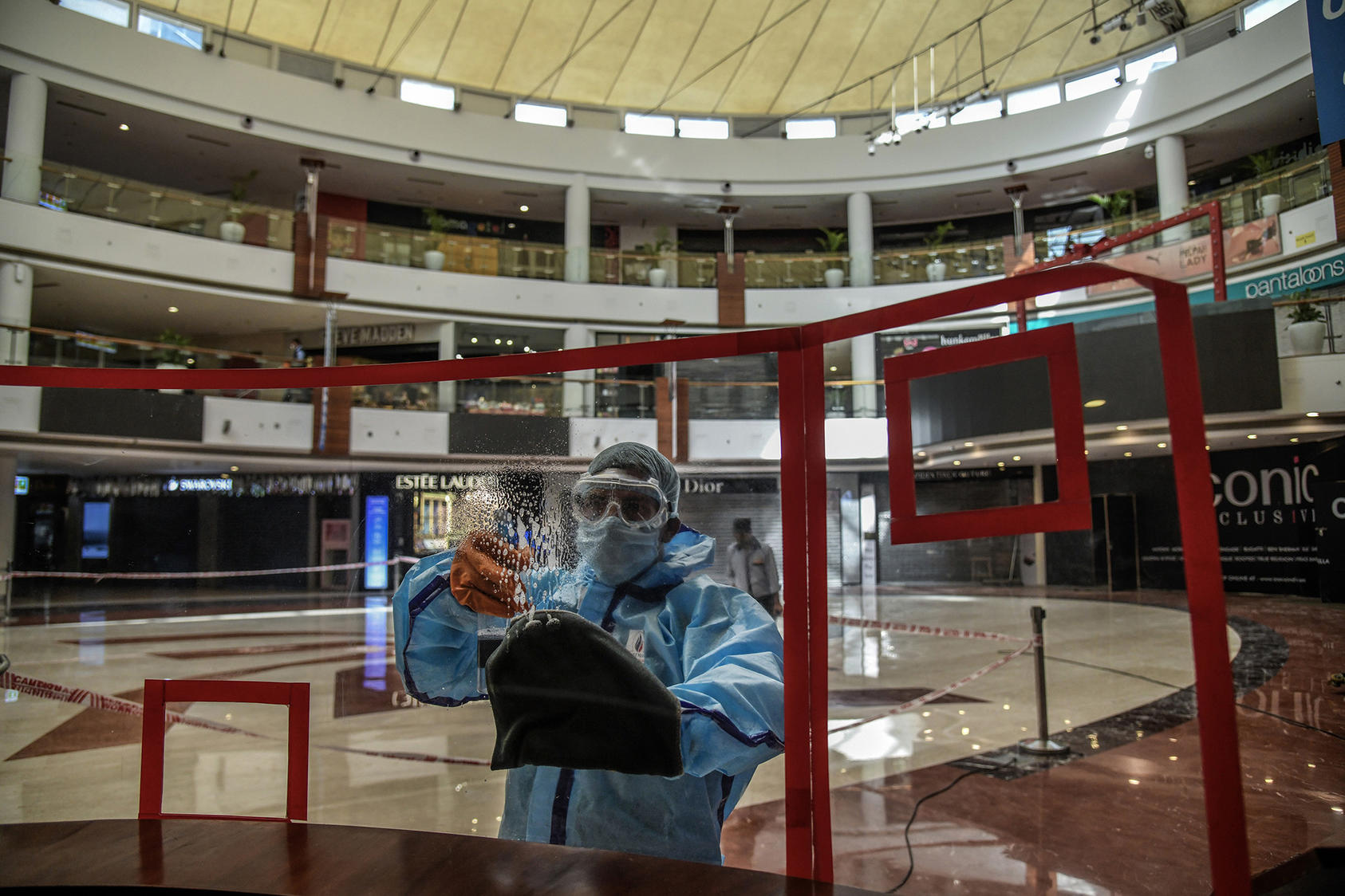 Workers sanitize the interior of a shopping mall in New Delhi, India, on June 6, 2021. (Photo by Atul Loke/New York Times)