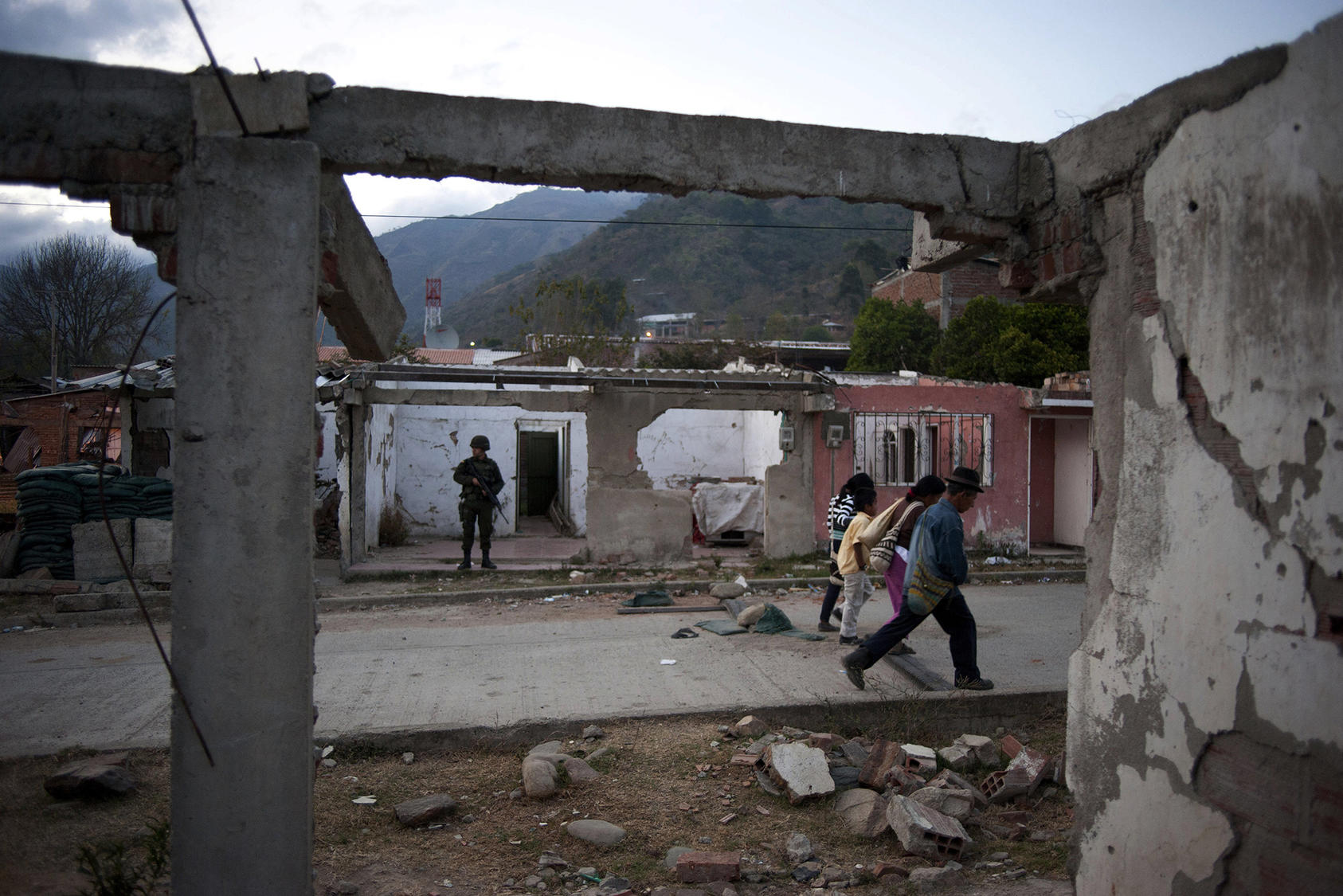 A Colombian soldier watched a street in Toribio, a mountain town in Colombia’s Pacific region, as peace talks began in 2012. Nine years later, the region remains violent, with little government presence in rural areas. (Stephen Ferry/The New York Times)