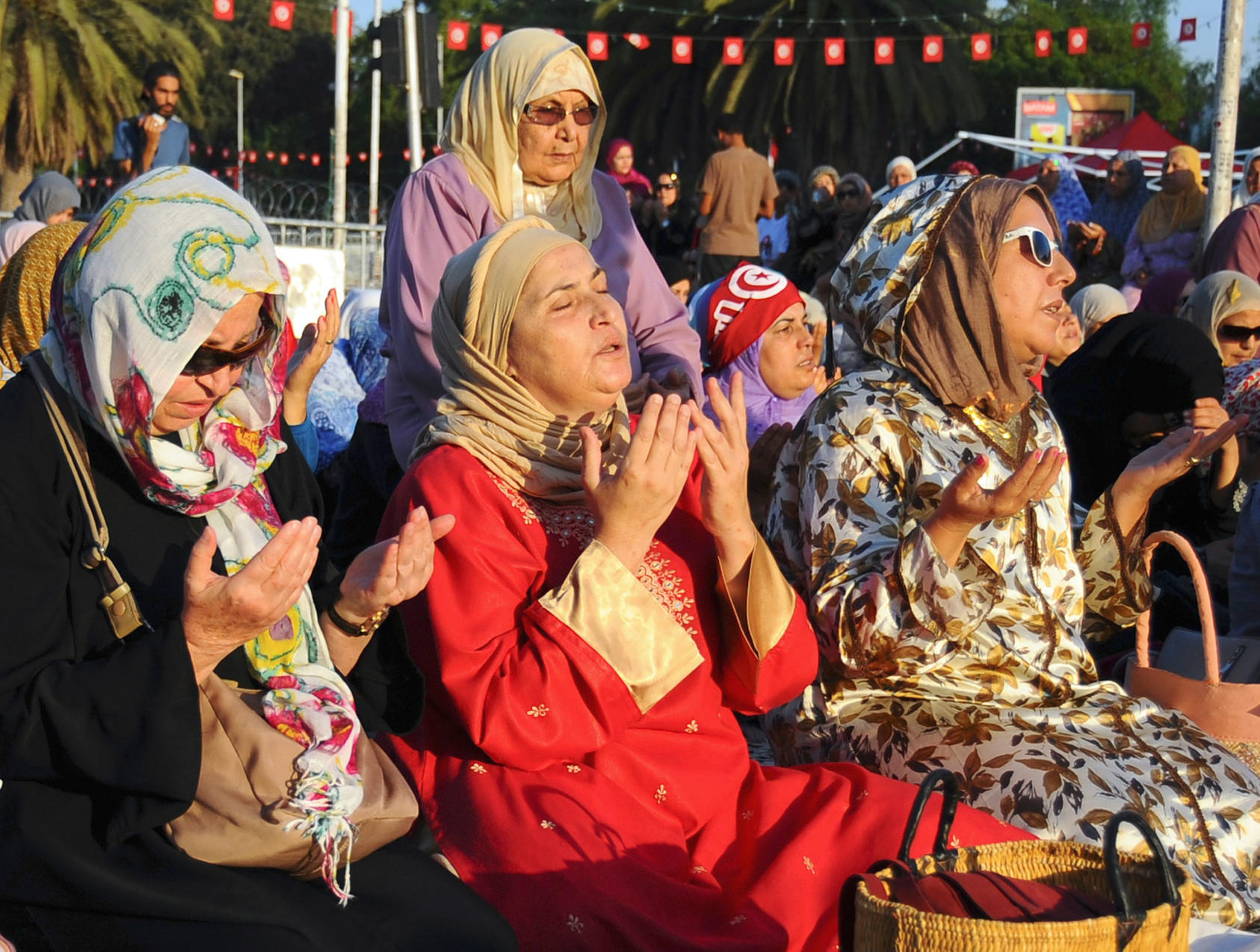 Women pray near the Zitouna Mosque in Tunis during the Eid al-Fitr holiday, marking the end of Ramadan, on August 8, 2013. (Photo by Hassene Dridi/AP)