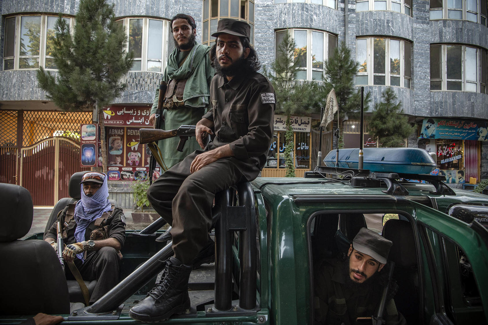 A unit of Taliban fighters, who now wear brown uniforms, in charge of car searches in Kabul, Afghanistan, Aug. 10, 2022. (Kiana Hayeri/The New York Times)