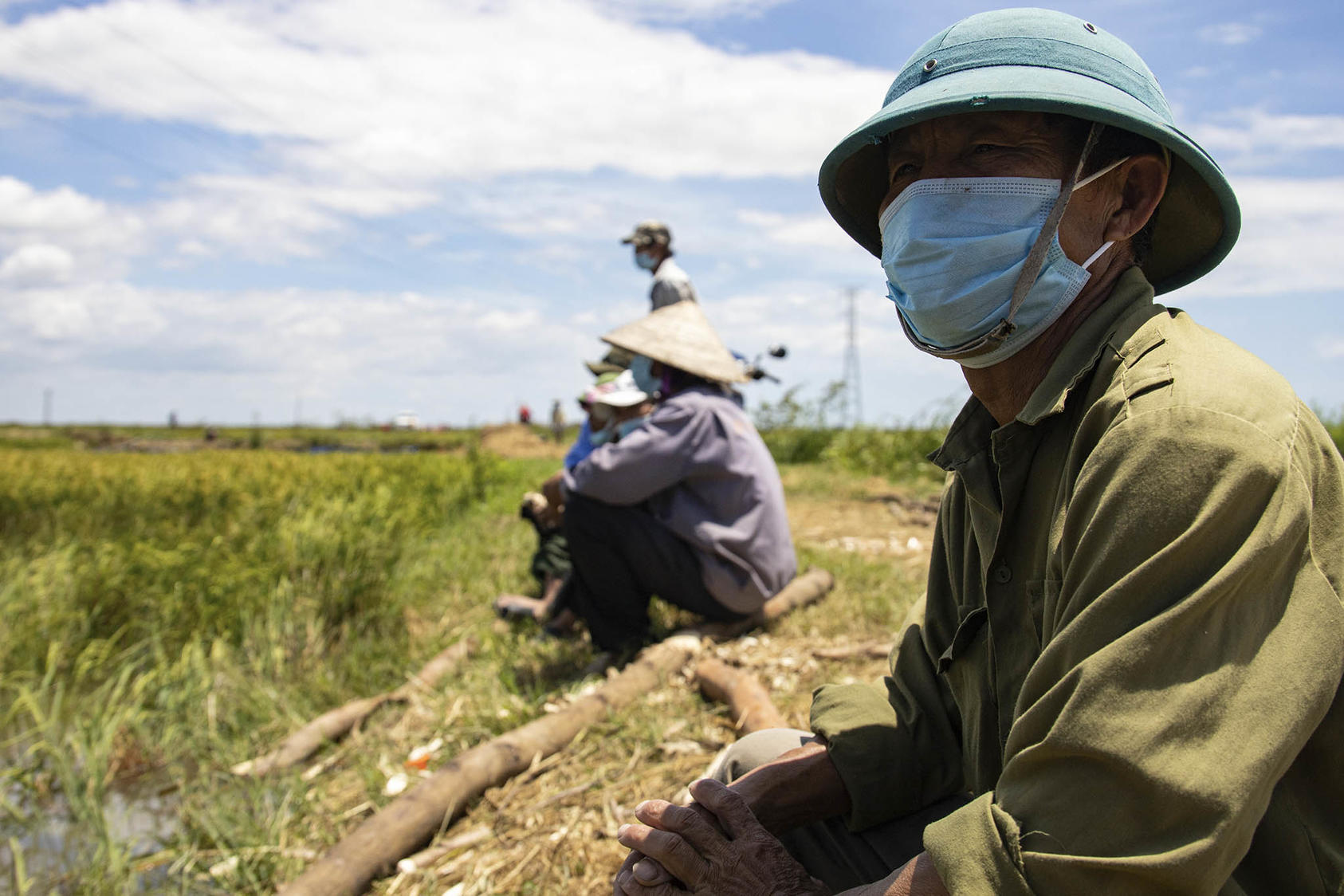 Vietnamese locals take a break from transporting dirt during a U.S.-led recovery mission in Quang Binh province, Vietnam. June 15, 2021. (Lance Cpl. Timothy Fowler/U.S. Marine Corps)