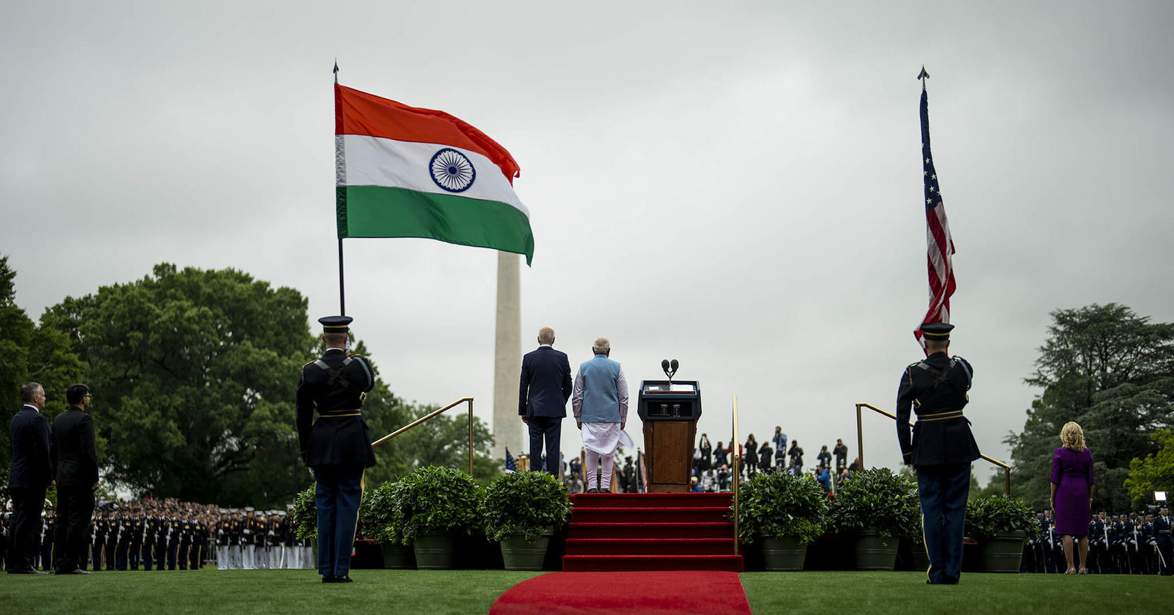 Soldiers hold Indian and American flags as President Joe Biden and Indian Prime Minister Narendra Modi of India take part in a State Arrival Ceremony on the South Lawn of the White House in Washington, June 22, 2023. (Doug Mills/The New York Times)