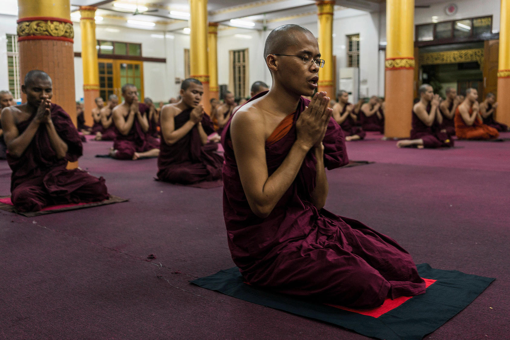Monks pray in the Bengala monastery in Yangon, Myanmar . (Adam Dean/The New York Times). 