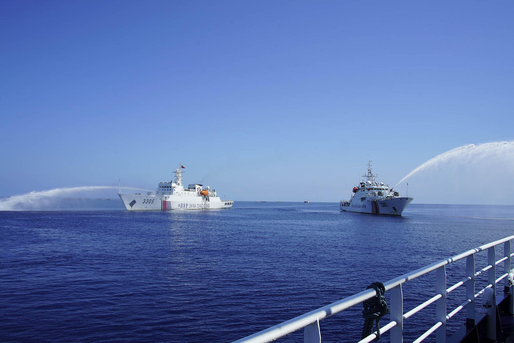 Chinese Coast Guard ships spray water cannons during an encounter with a Philippine government boat on its way to the Scarborough Shoal in the South China Sea on December 9, 2023. (Camille Elemia/The New York Times)