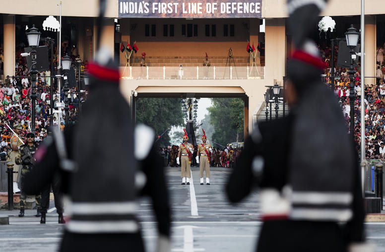 Pakistani, foreground, and Indian border guards mimc each other's movements during their daily ceremonial face off, at the Wagah-Attari border crossing, Sept. 28, 2019. (Mustafa Hussain/The New York Times)