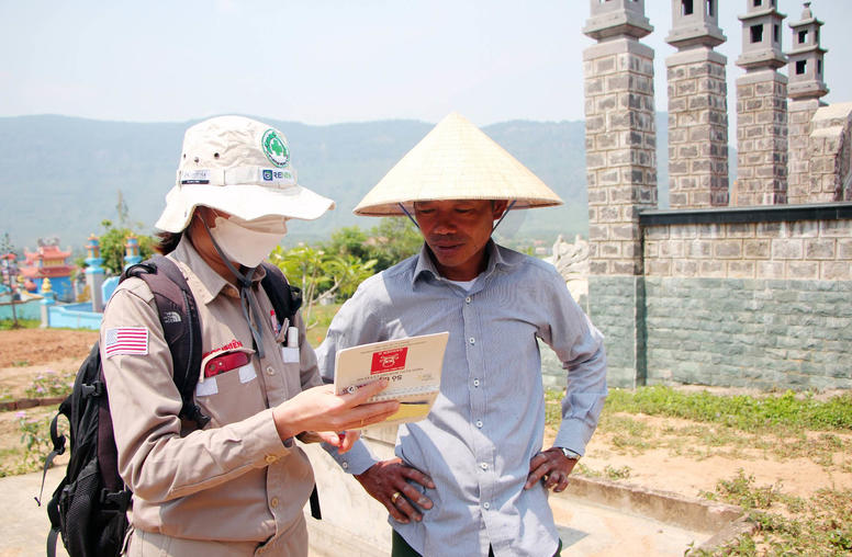 Nguyen Ngoc Nhien interviews a local informant to gather evidence of exploded ordnance contamination in Huang Hoa district in Quang Tri province, Vietnam. (Project RENEW)