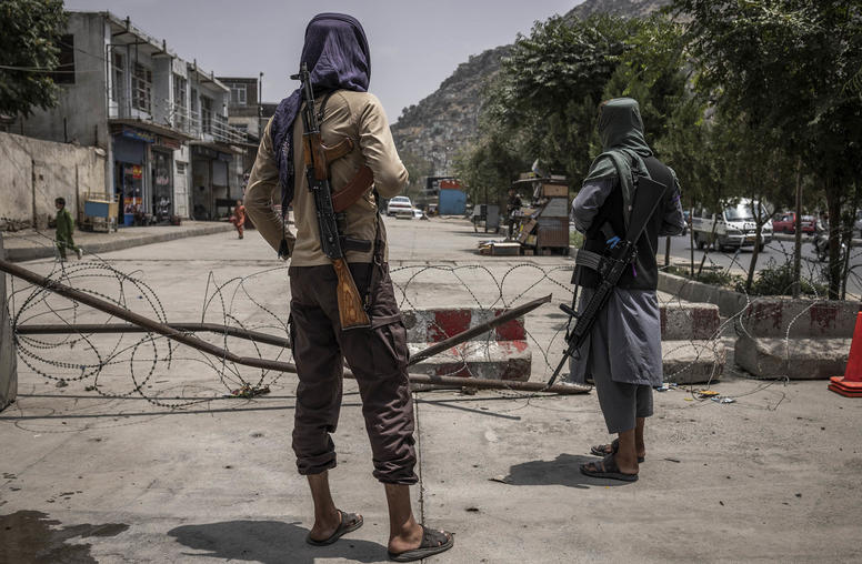 Two Taliban fighters-turned-policemen at their police post in Kabul, Afghanistan. July 23, 2023. (Jim Huylebroek/The New York Times)