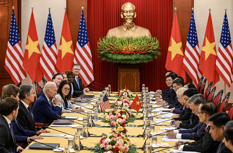 President Biden sits across from Vietnam’s leader, Nguyen Phu Trong, and Vietnamese officials during a meeting at Communist Party headquarters in Hanoi on Sunday, Sept. 10, 2023. (Kenny Holston/The New York Times)
