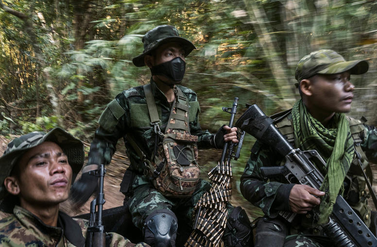 Members of an ethnic militia in the back of a pickup truck patrol a frontline area near government military positions in Myanmar’s Kayin State on March 9, 2022. (Adam Dean/The New York Times)